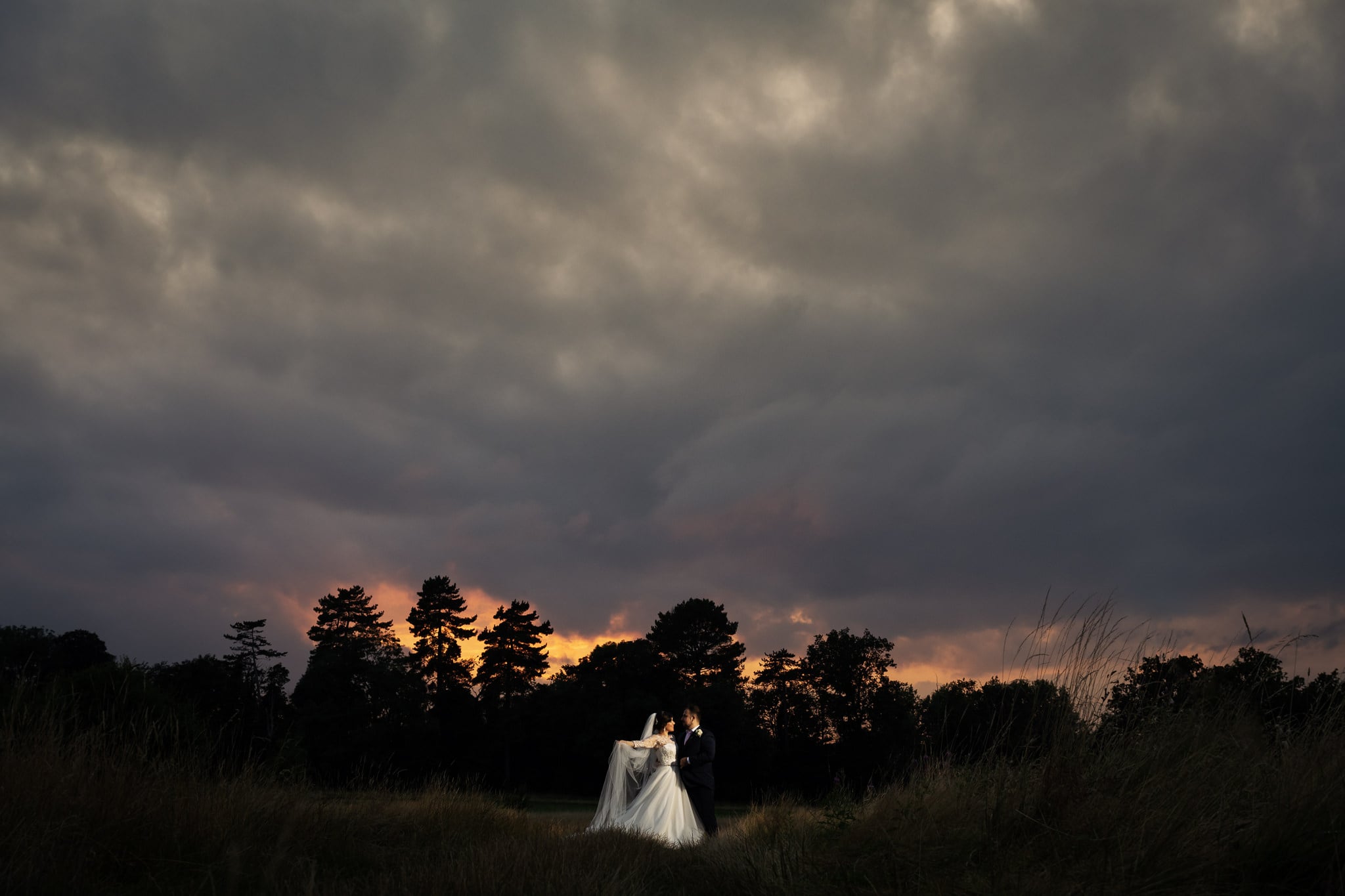 A sunset bride and groom portrait at Aldwickbury Park Golf Club wedding