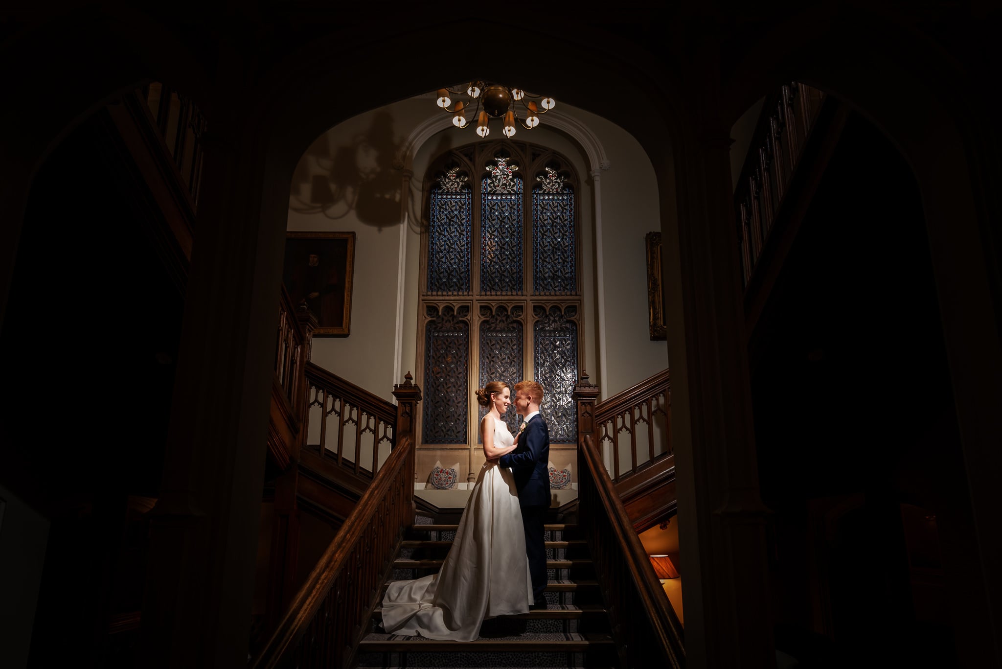 Portrait of bride and groom on the staircase at De Vere Latimer Estate wedding