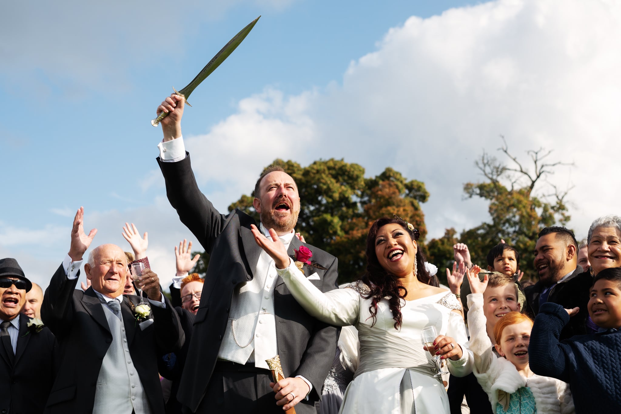Bride and groom with guests cheering at Lord of the Rings themed wedding