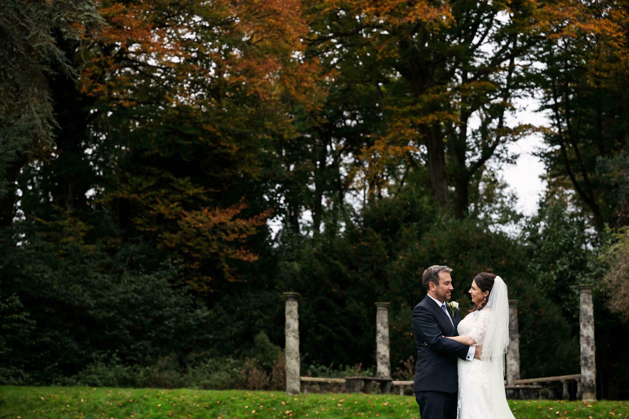 Portrait of bride and groom in grounds of Pendley Manor
