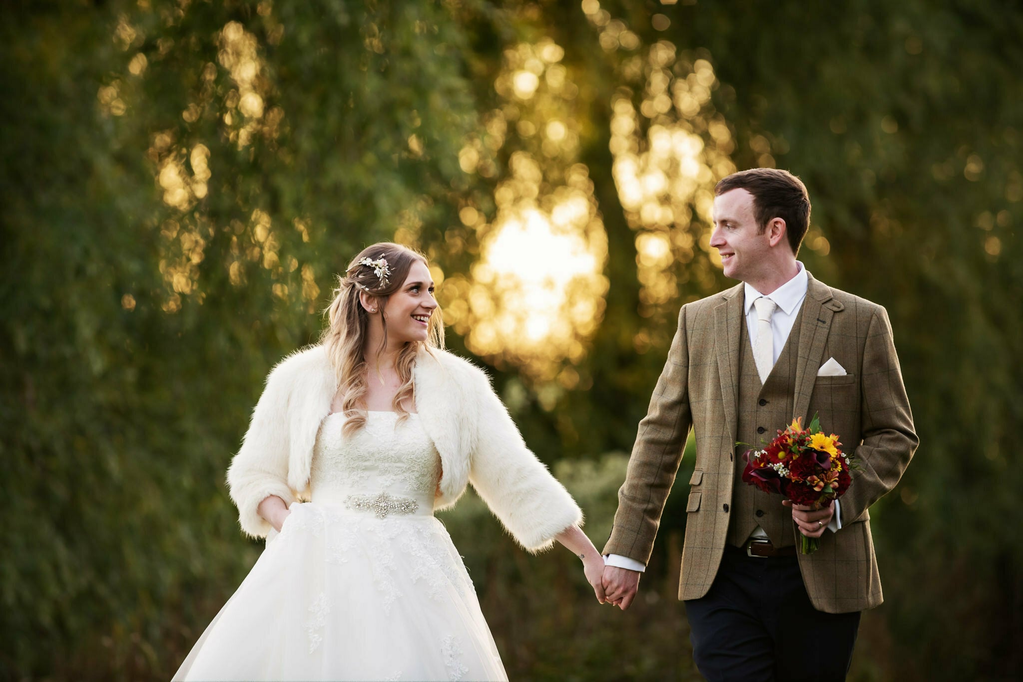 Bride and groom walking at Priory Little Wymondley wedding