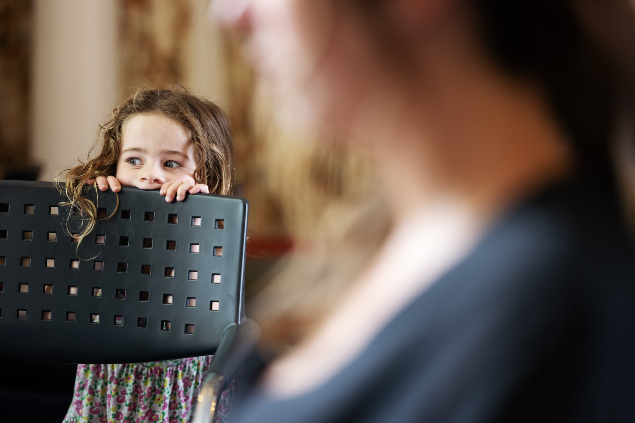A candid photo of the flower girl during bride prep.