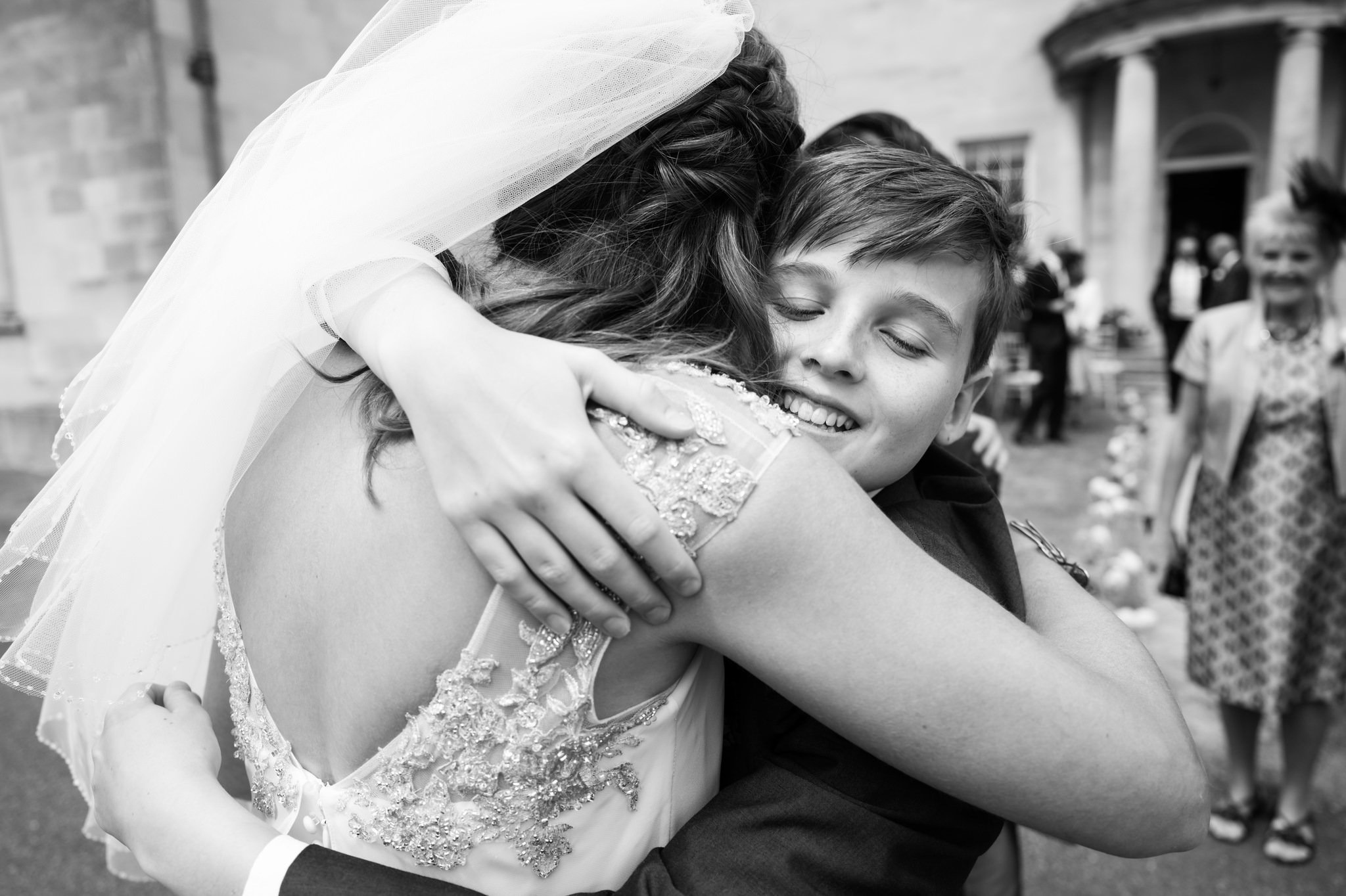 A candid photo of the bride hugging her new son-in-law.