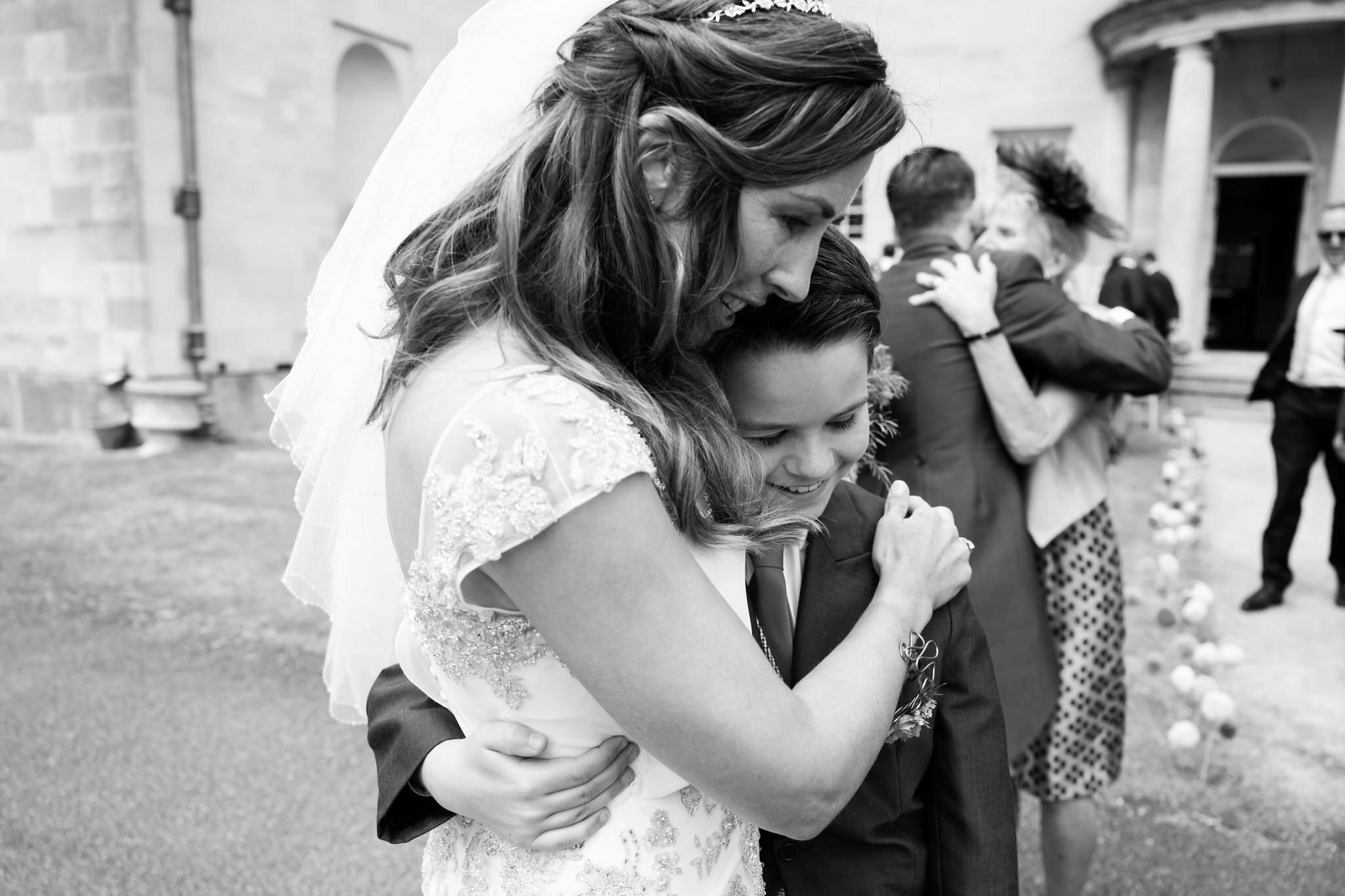 A candid photo of the bride hugging her new son-in-law.