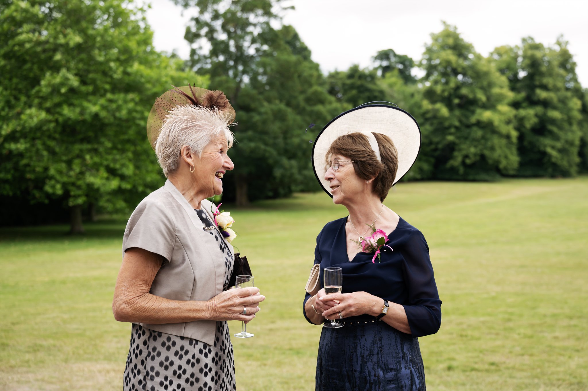 The mother of the groom talks with the mother of the bride during the wedding reception.