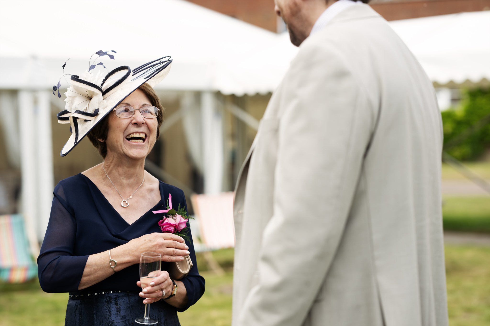 A candid photo of the mother of the bride talking with a wedding guest.