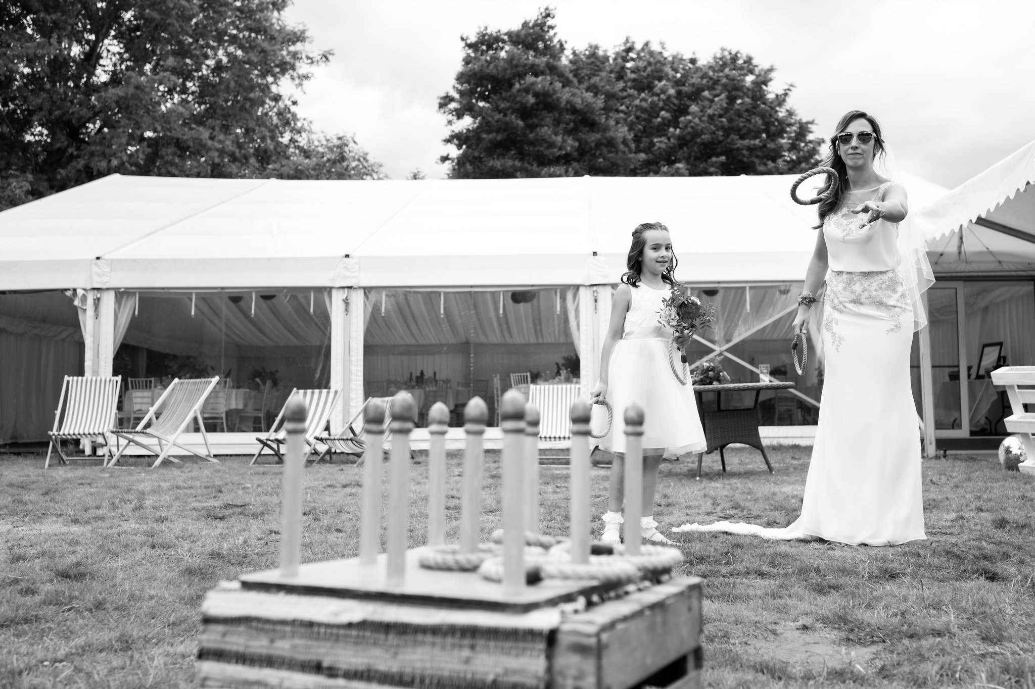 The bride and the flower girl play festival style games at Hitchin Priory.