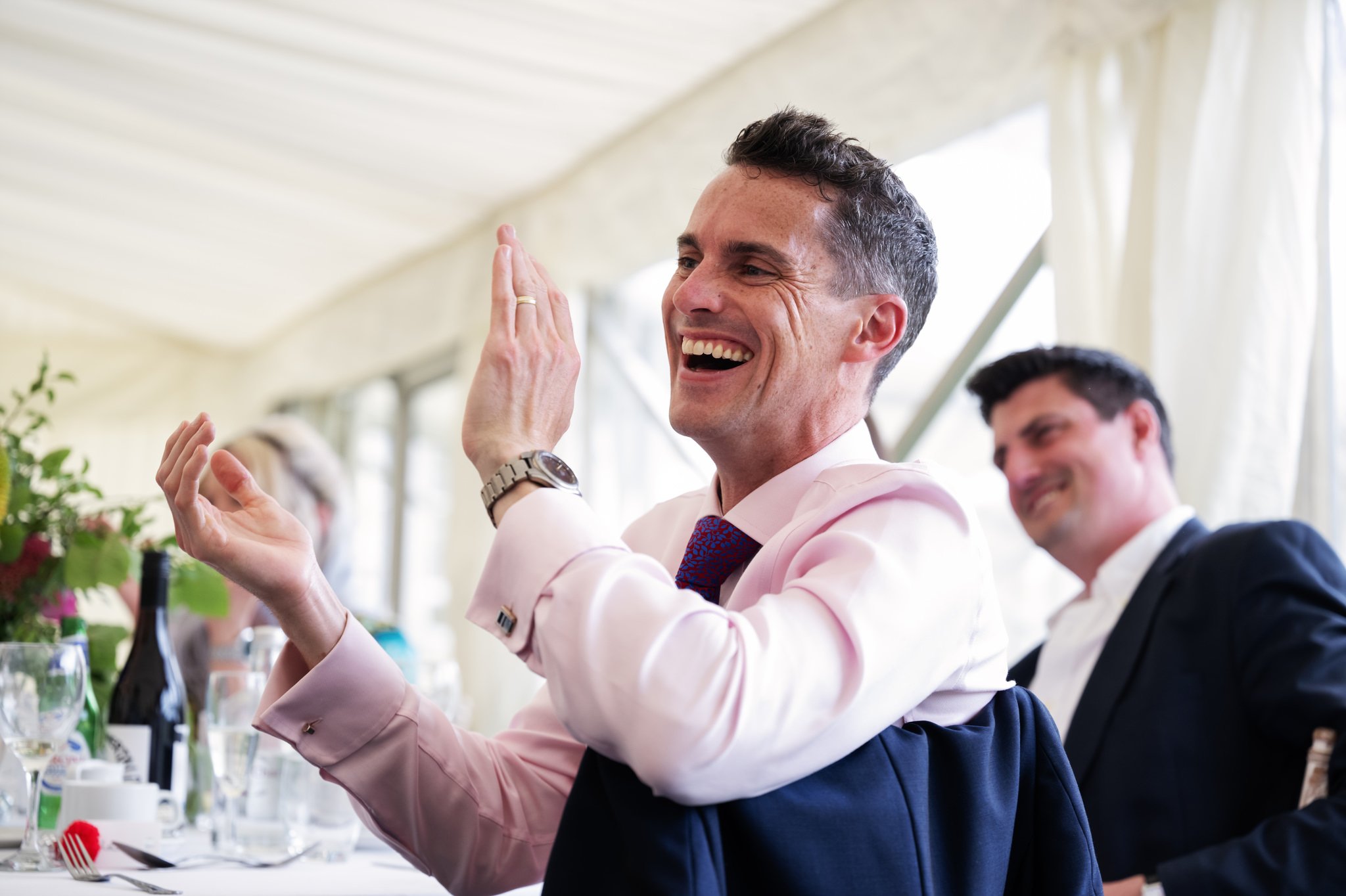 Wedding guests clapping during the speeches.