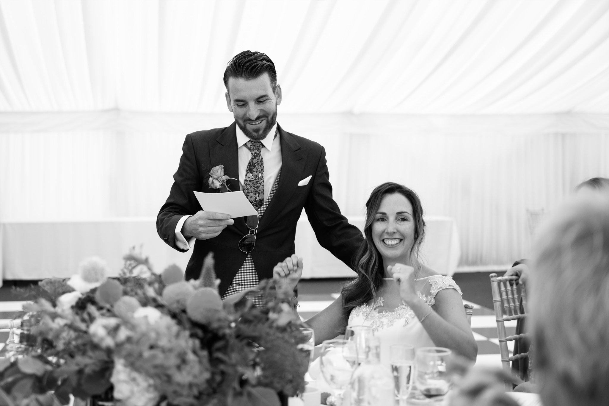The groom standing up giving his speech stood next to the Bride.