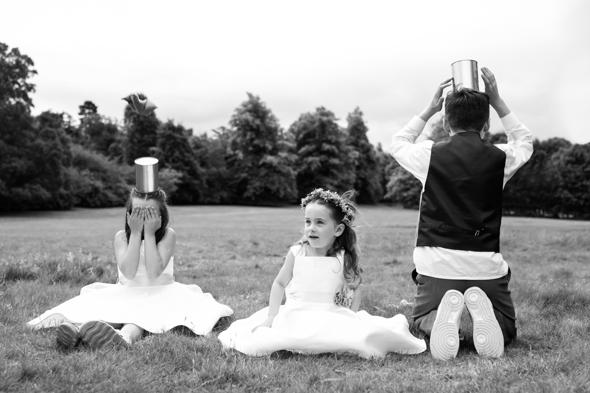 A candid photo of 3 kids playing at a Hitchin Priory wedding. Hertfordshire documentary photographer.