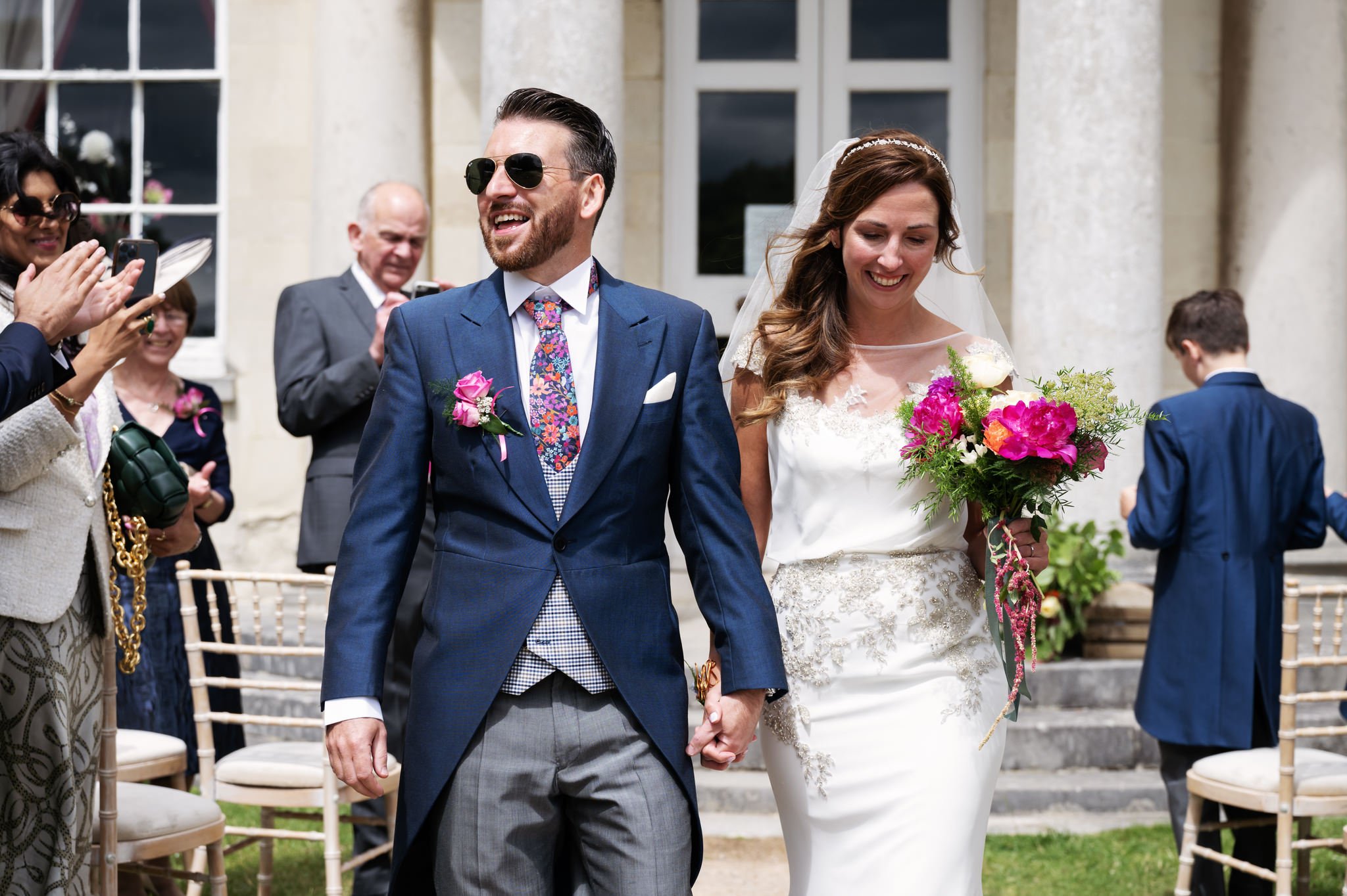 Hitchin Priory wedding photography. The bride and groom walk back down the aisle at the end of the wedding ceremony.