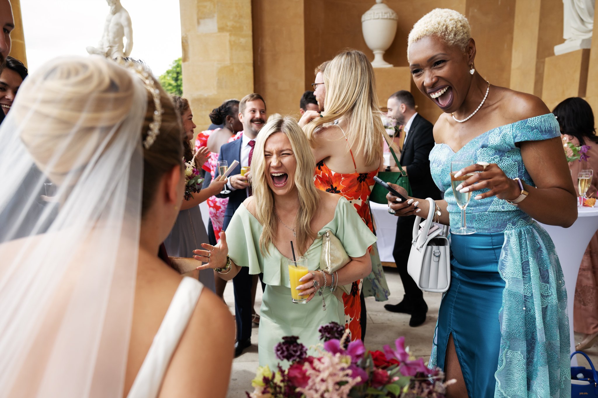 Wedding guests excitedly congratulates the bride.