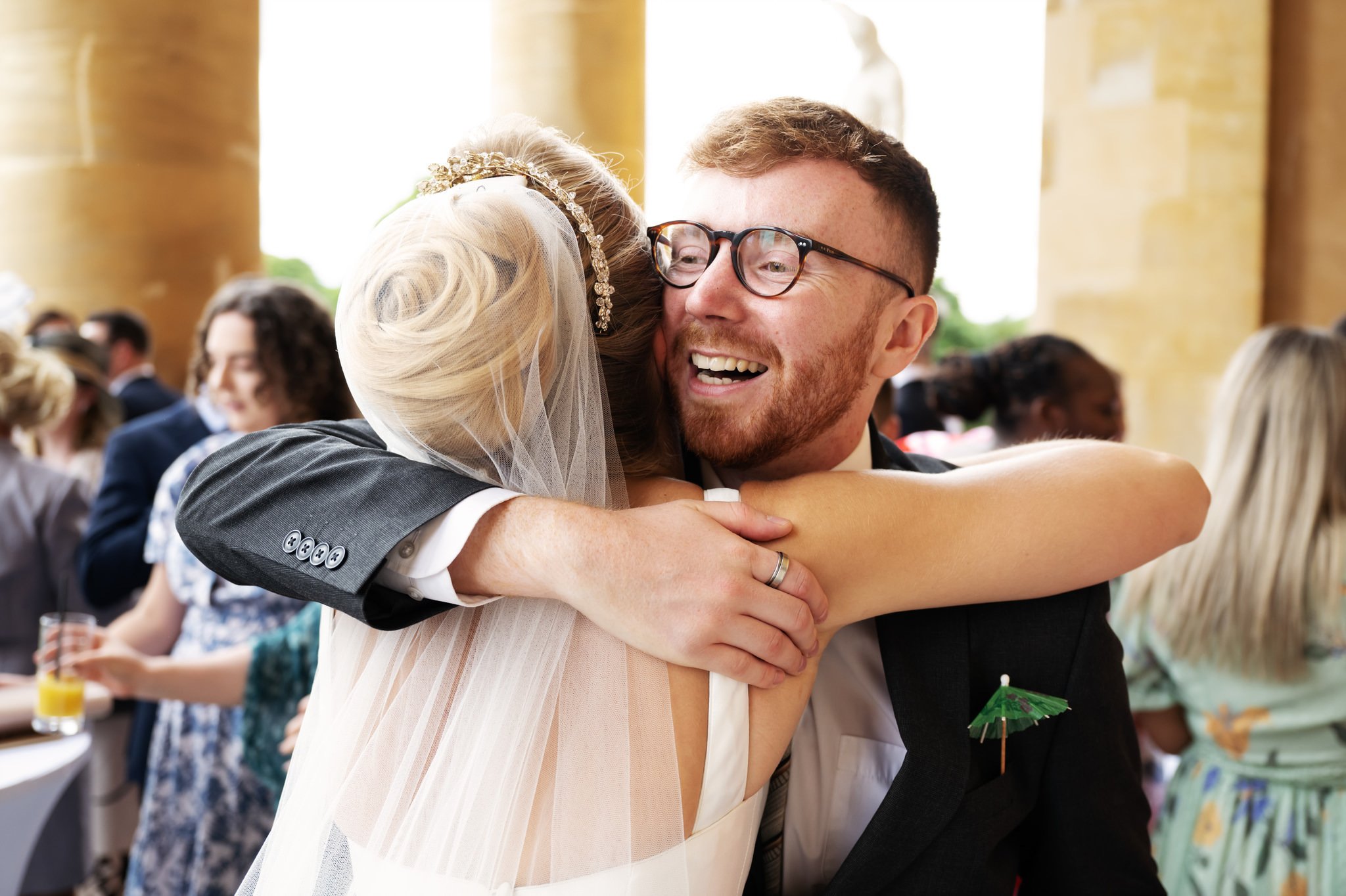 A wedding guest gives the bride a hug at a Stowe House wedding.
