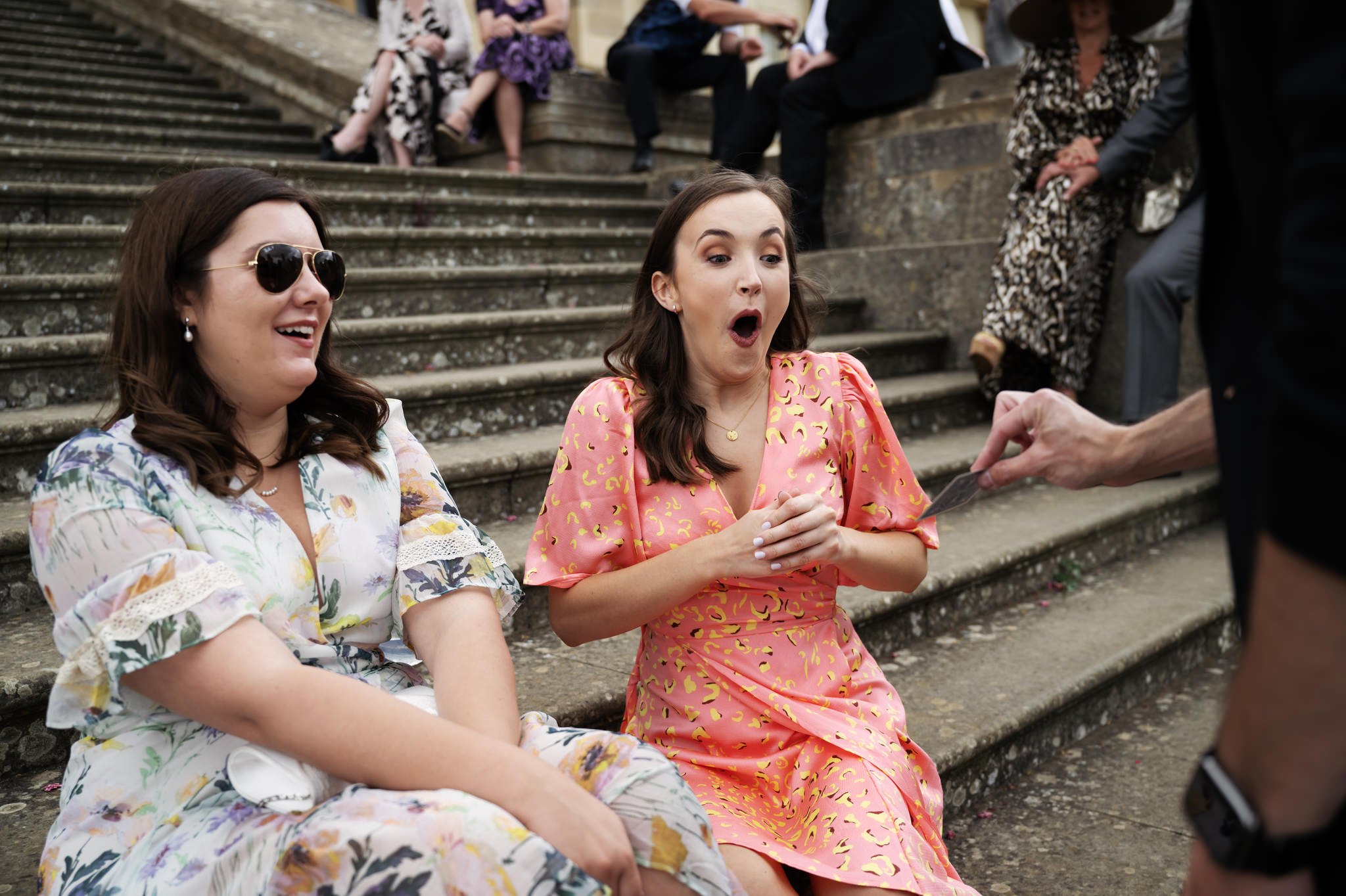Wedding guests  are surprised at the end of a magic trick at Stowe House.