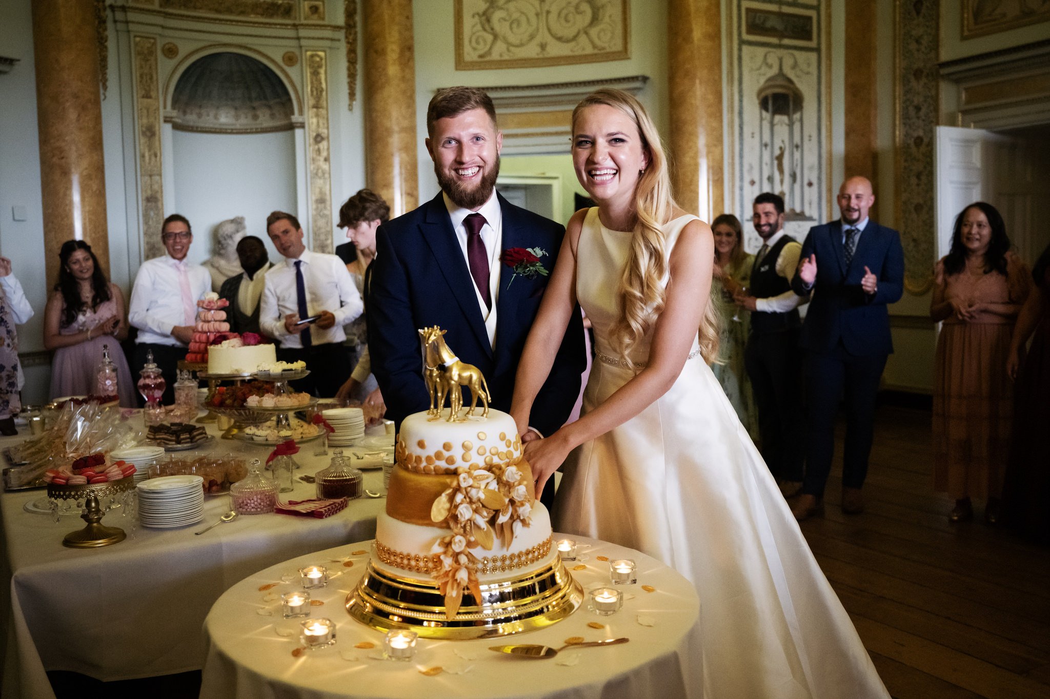 The bride and groom cut their wedding cake at Stowe House.