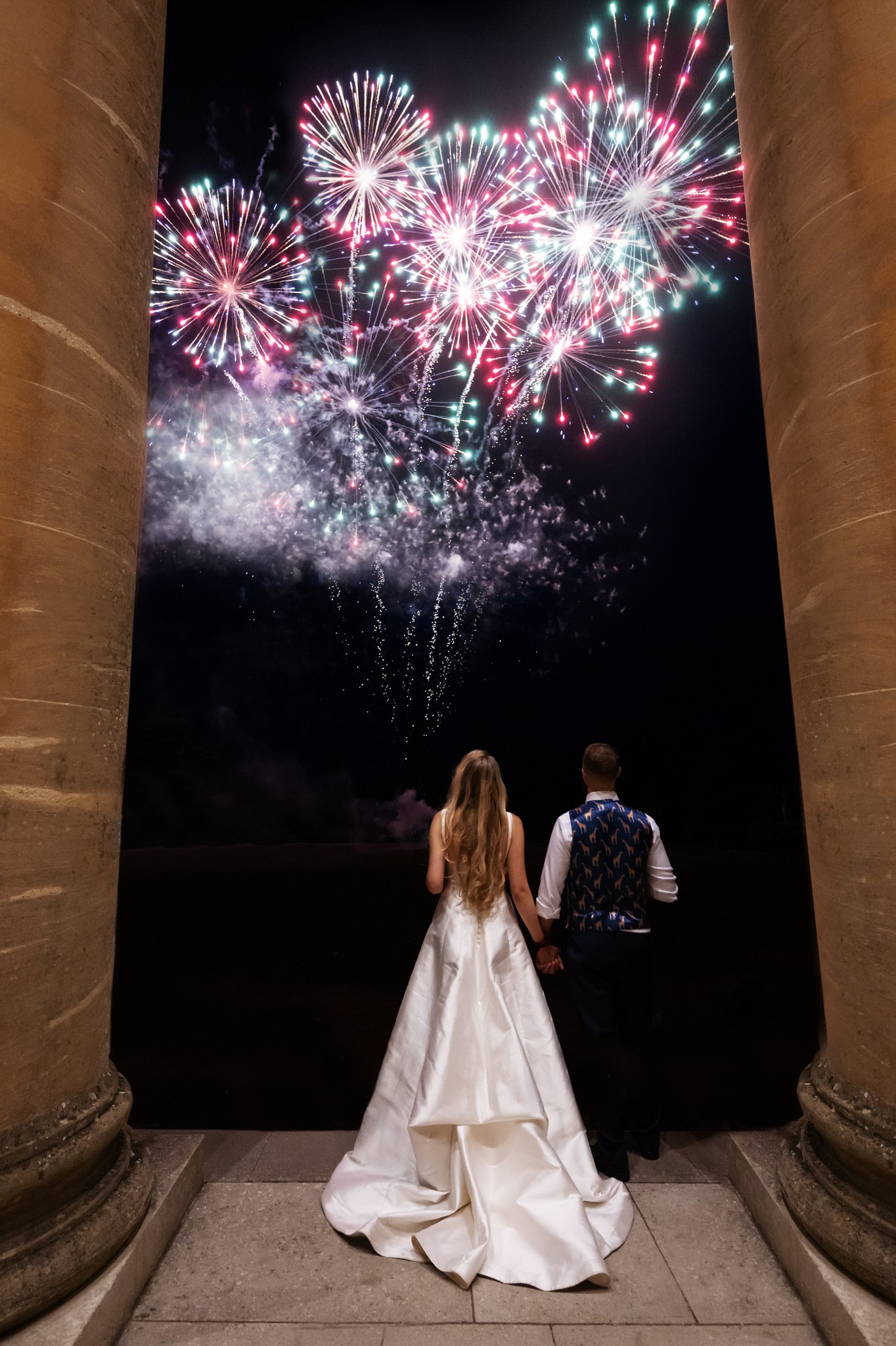 The bride and groom watch fireworks at Stowe House.