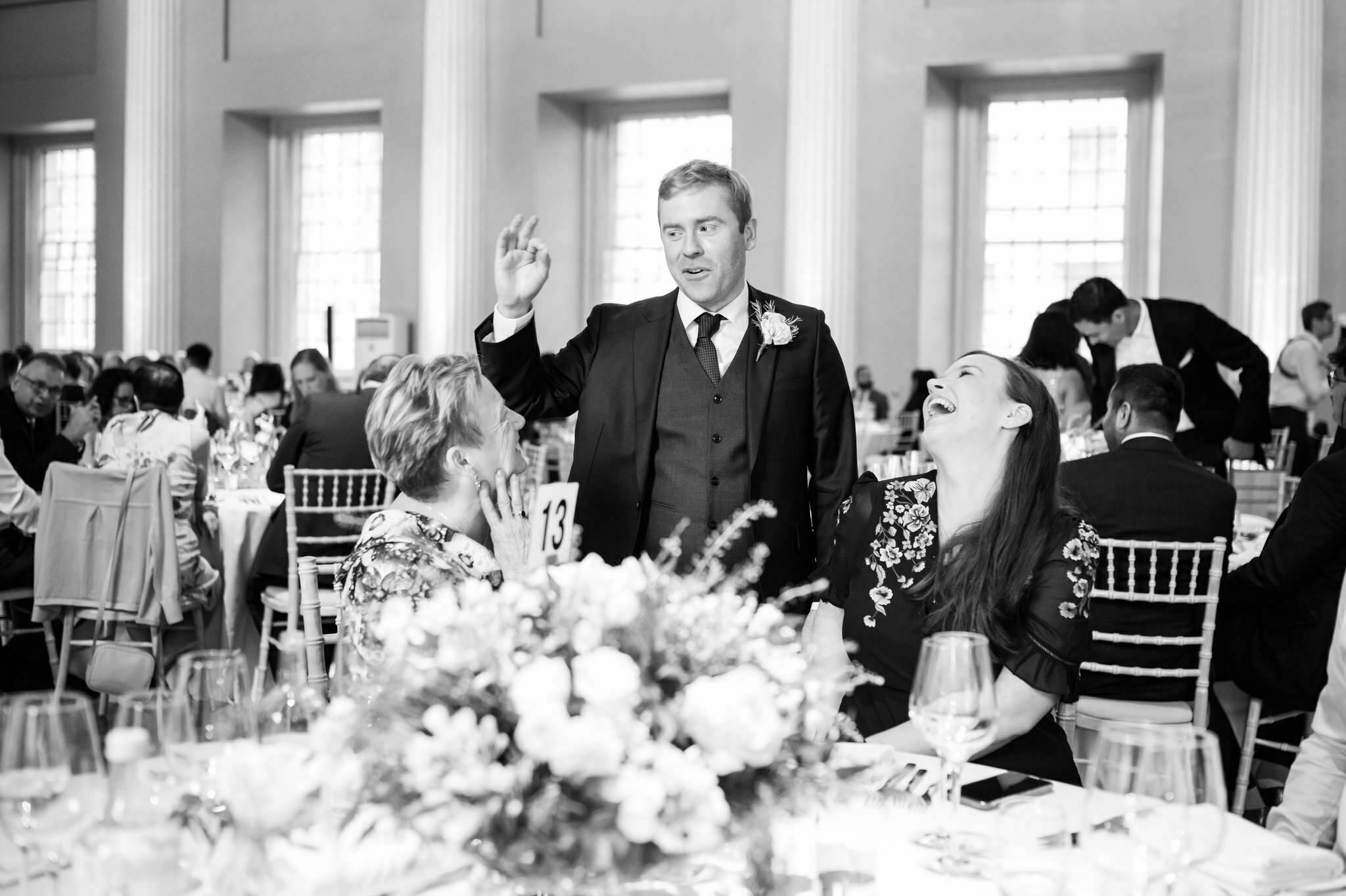 The groom talks with his wedding guests.