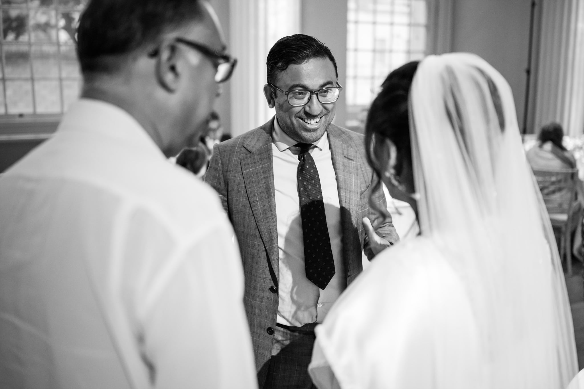 A candid photo of a wedding guest talking with the Bride.