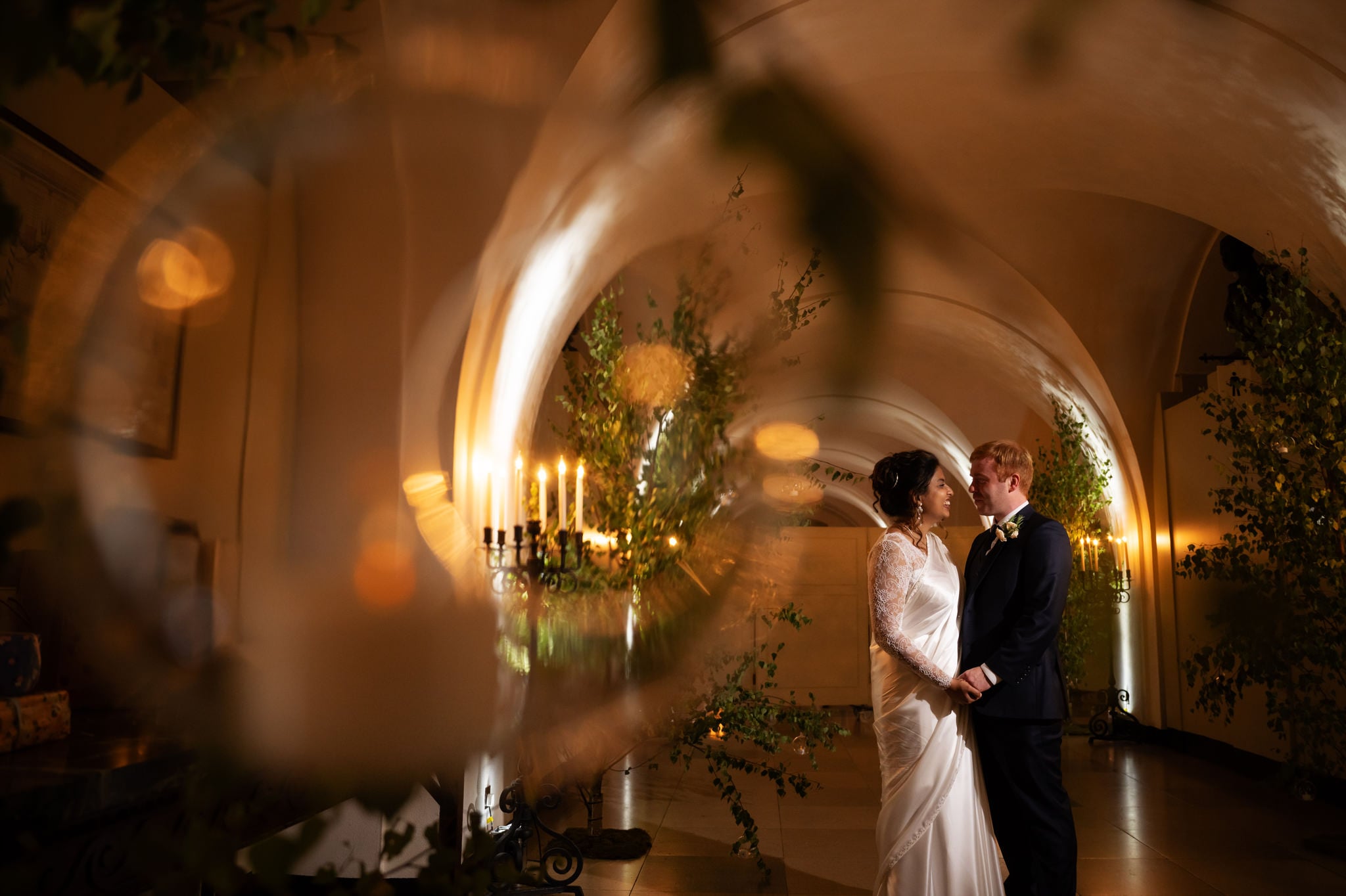 A portrait of the bride and groom in the Undercroft at banqueting house. The bride and groom are lit by flash.