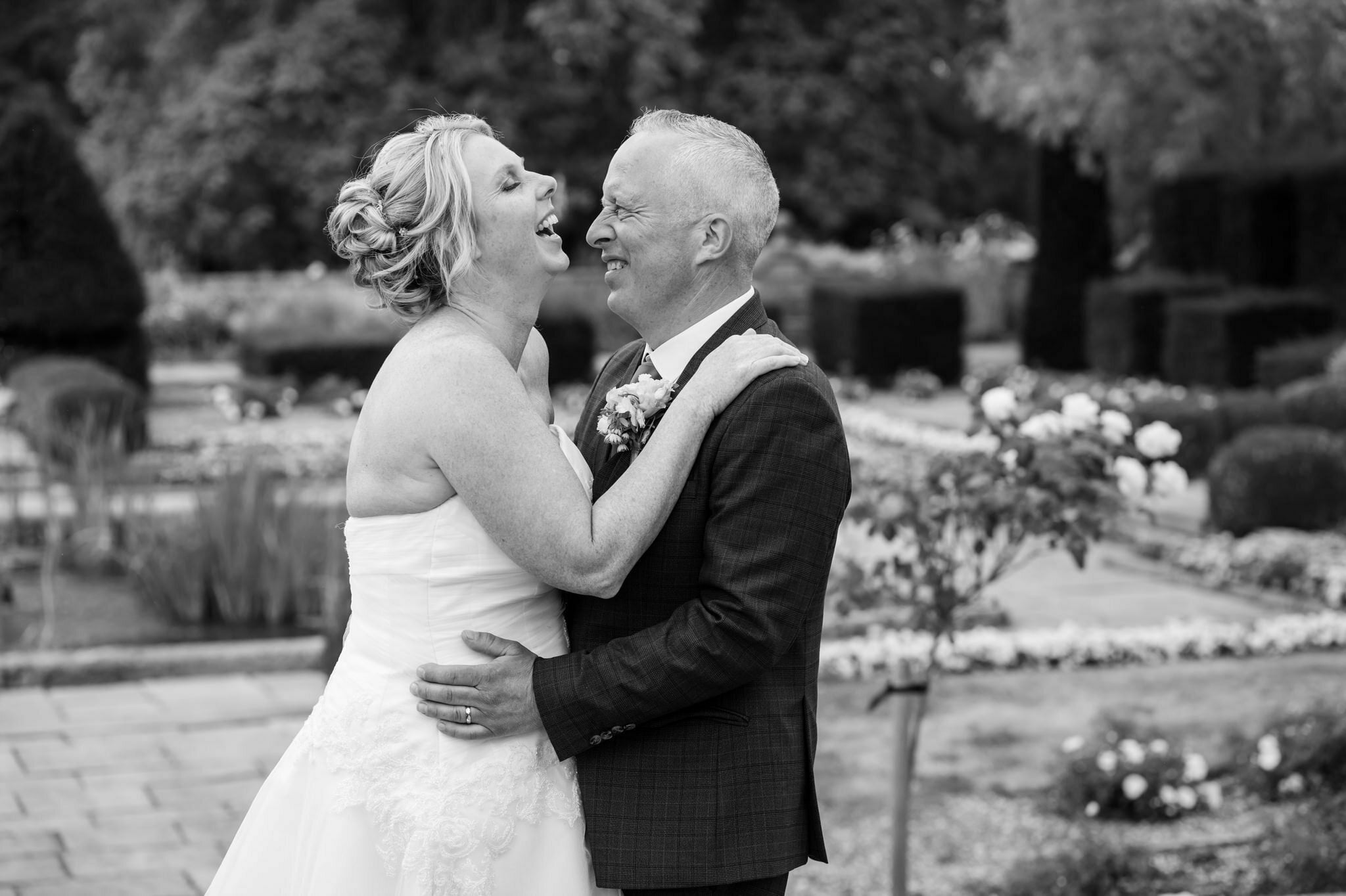The bride and groom laugh with each other during portraits at Fanhams Hall.