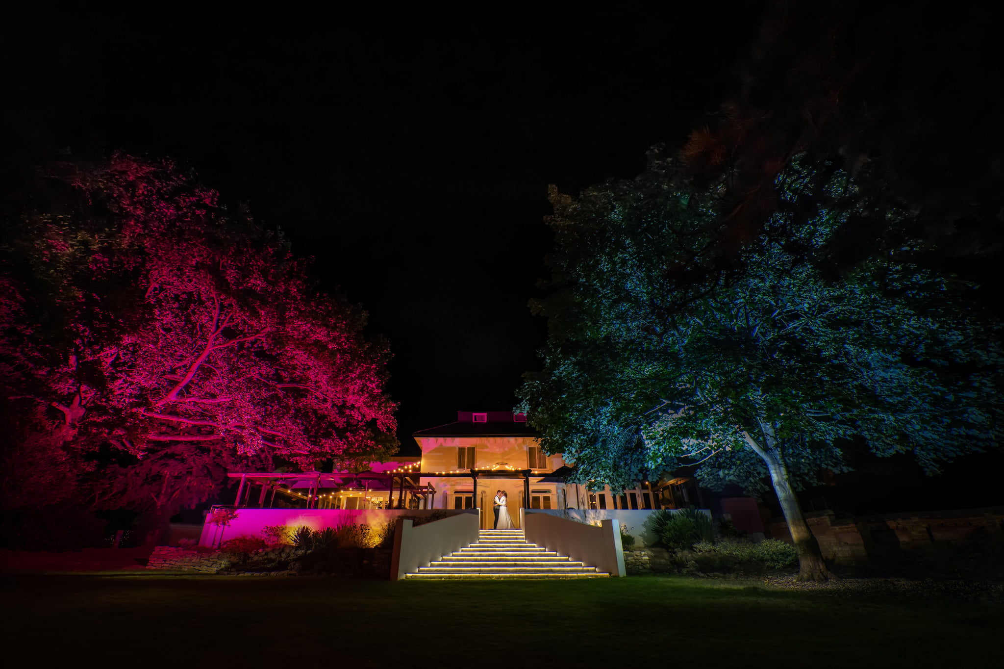 A night time portrait of the bride and groom at Hawkwell House wedding