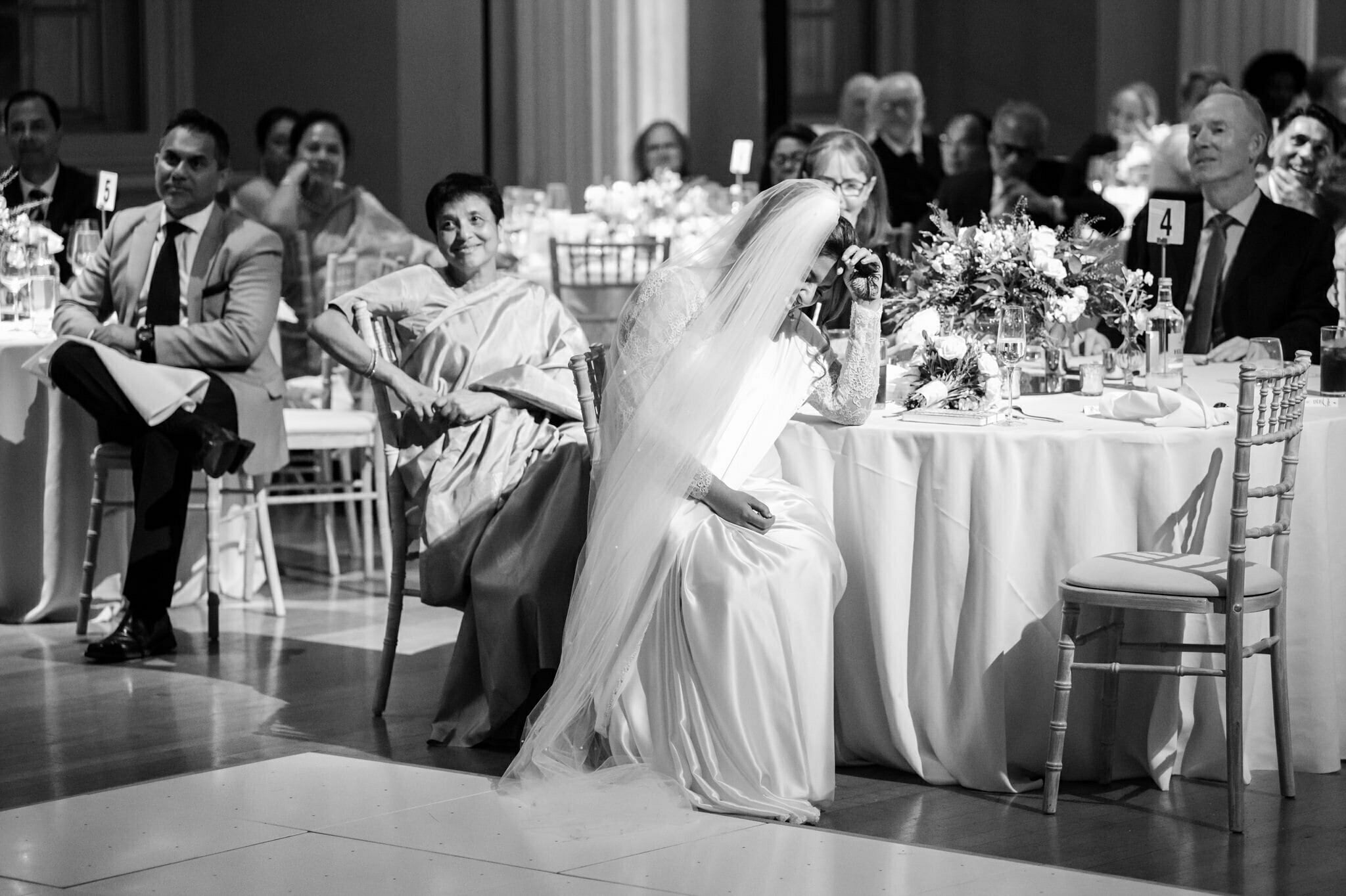 The Bride reacts while listening to the speeches