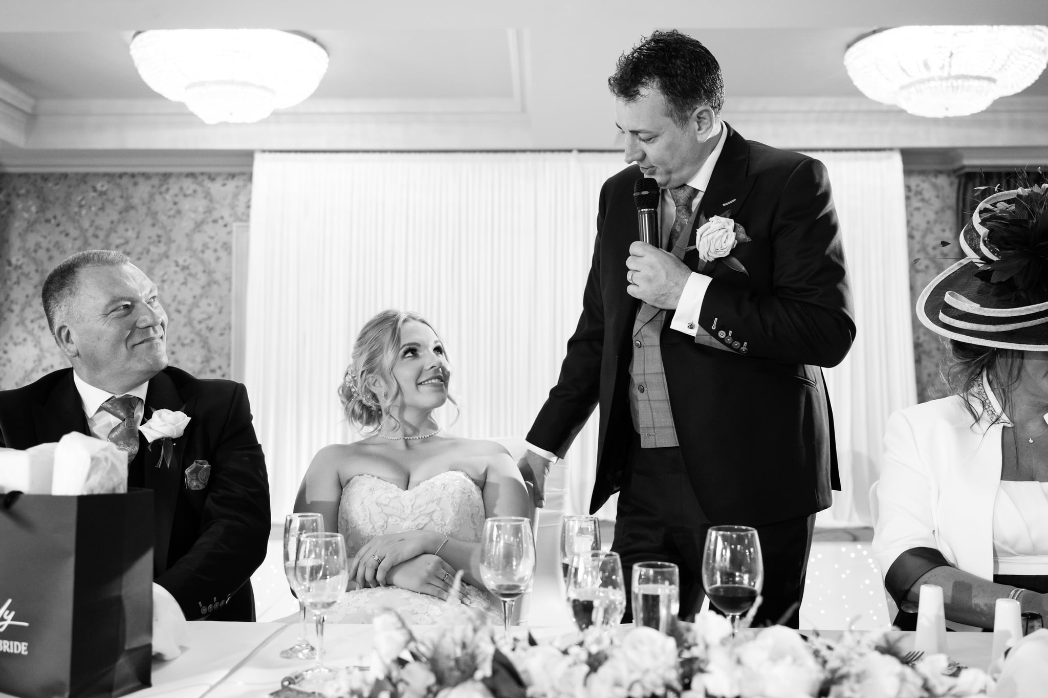 The Bride looks up at the groom during the grooms wedding speech.