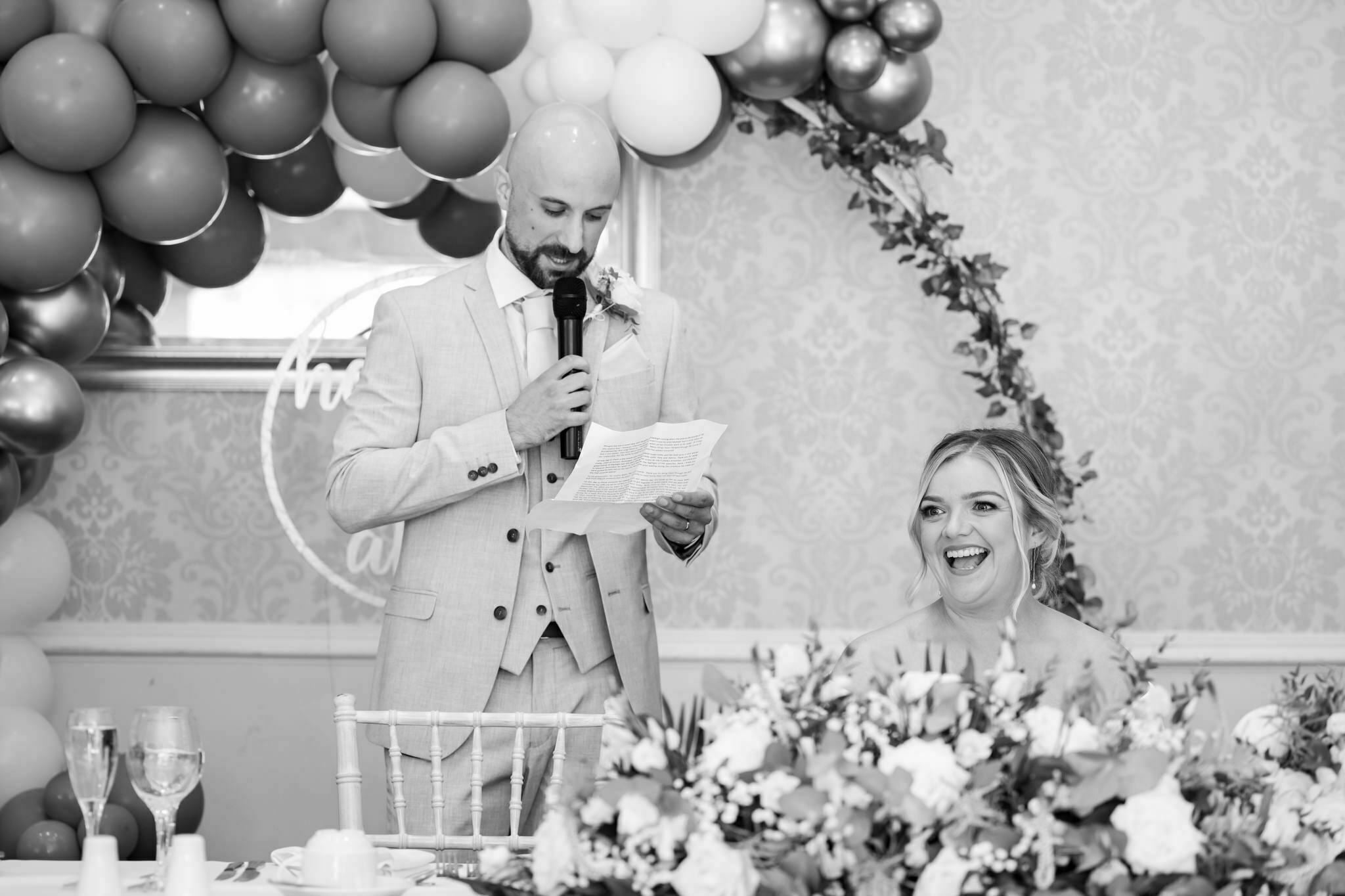 The groom gives his is wedding speech stood in front of a balloon arch in the Apsley Suite.