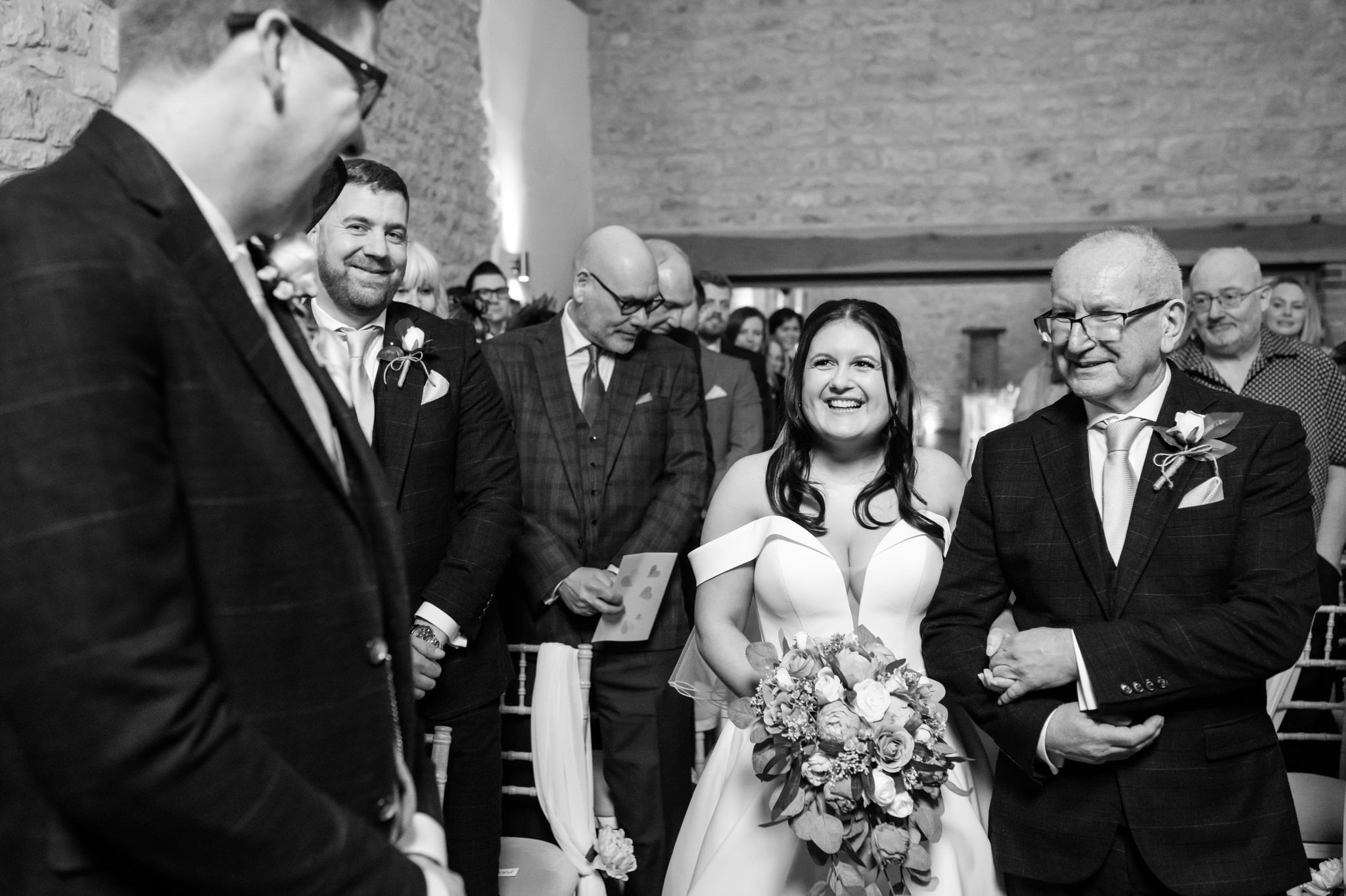 A Huntsmill Farm wedding photographer captures the bride walking down the aisle with her father.