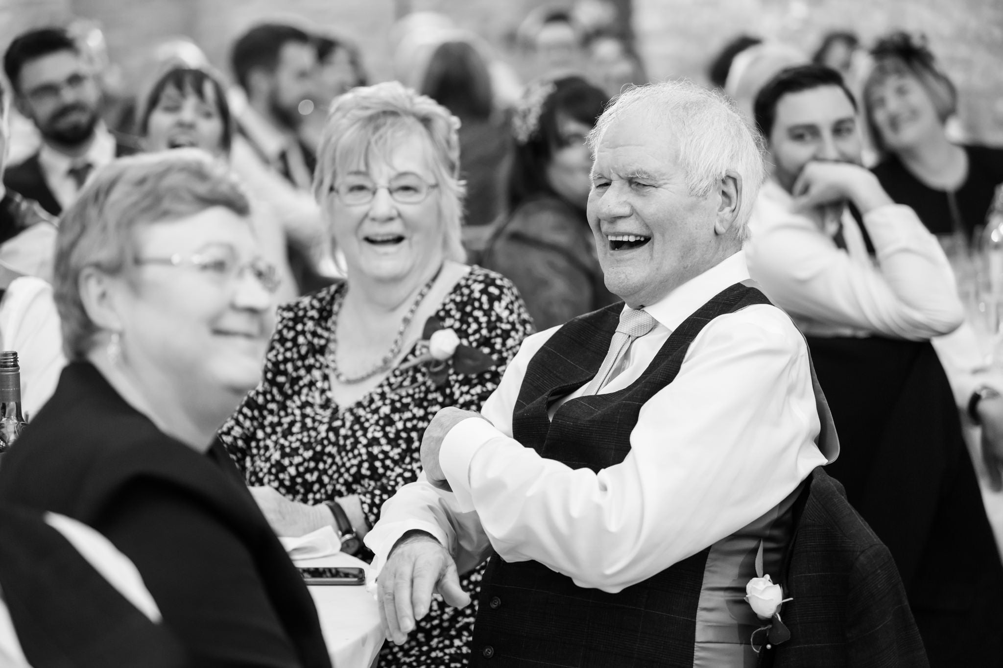 Huntsmill Farm wedding photographer captures black and white laughter at a wedding.