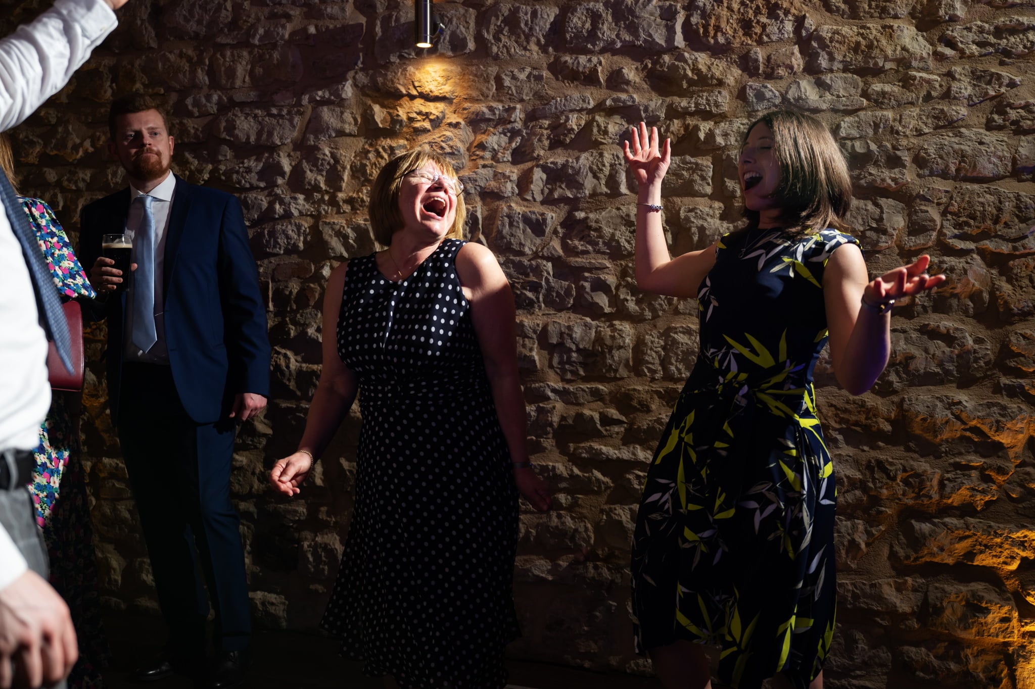 Huntsmill Farm Wedding Photographer captures a lively group of people having fun at a party.