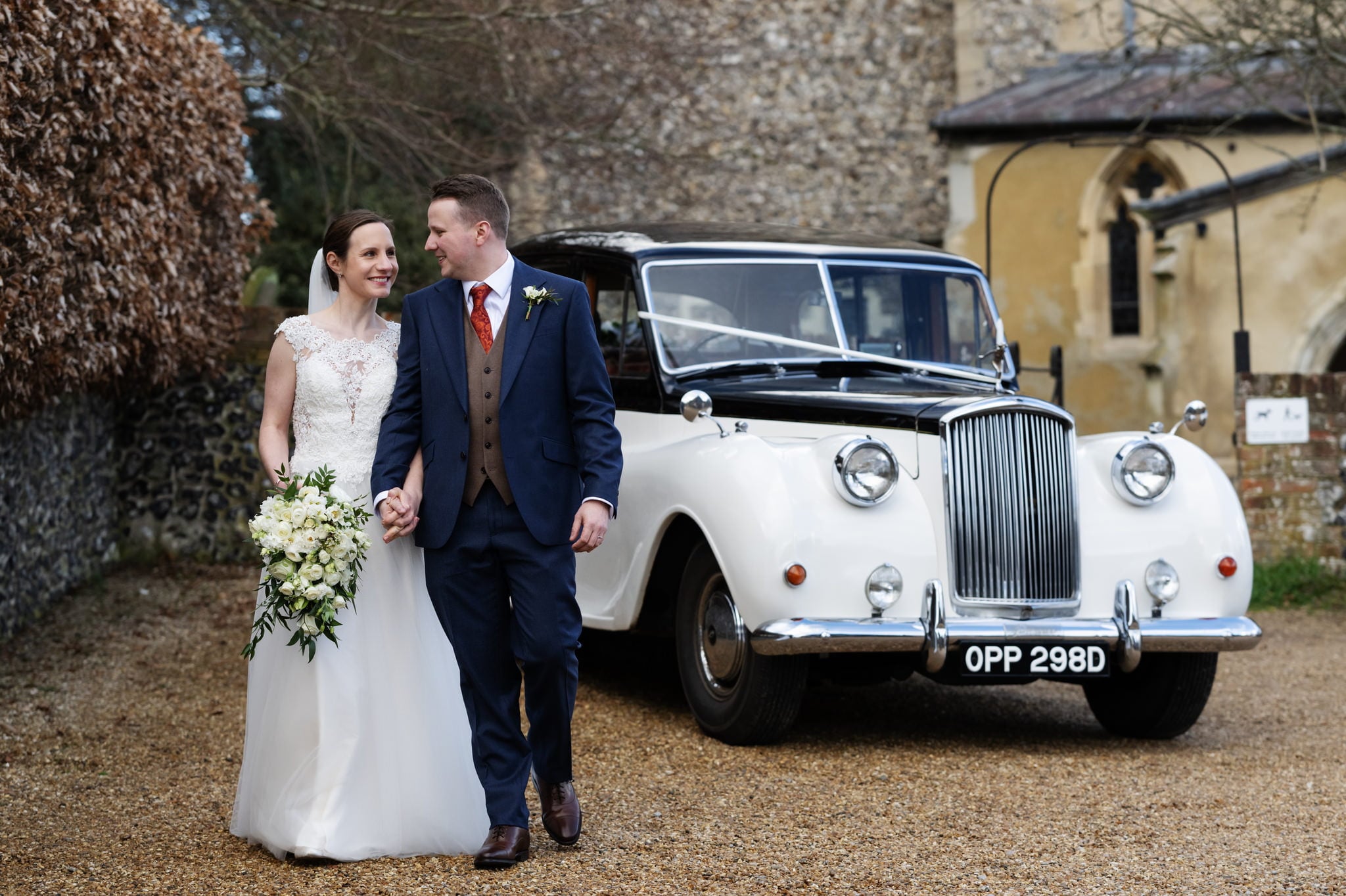 Bride and groom portrait with their wedding car in Berkhamsted