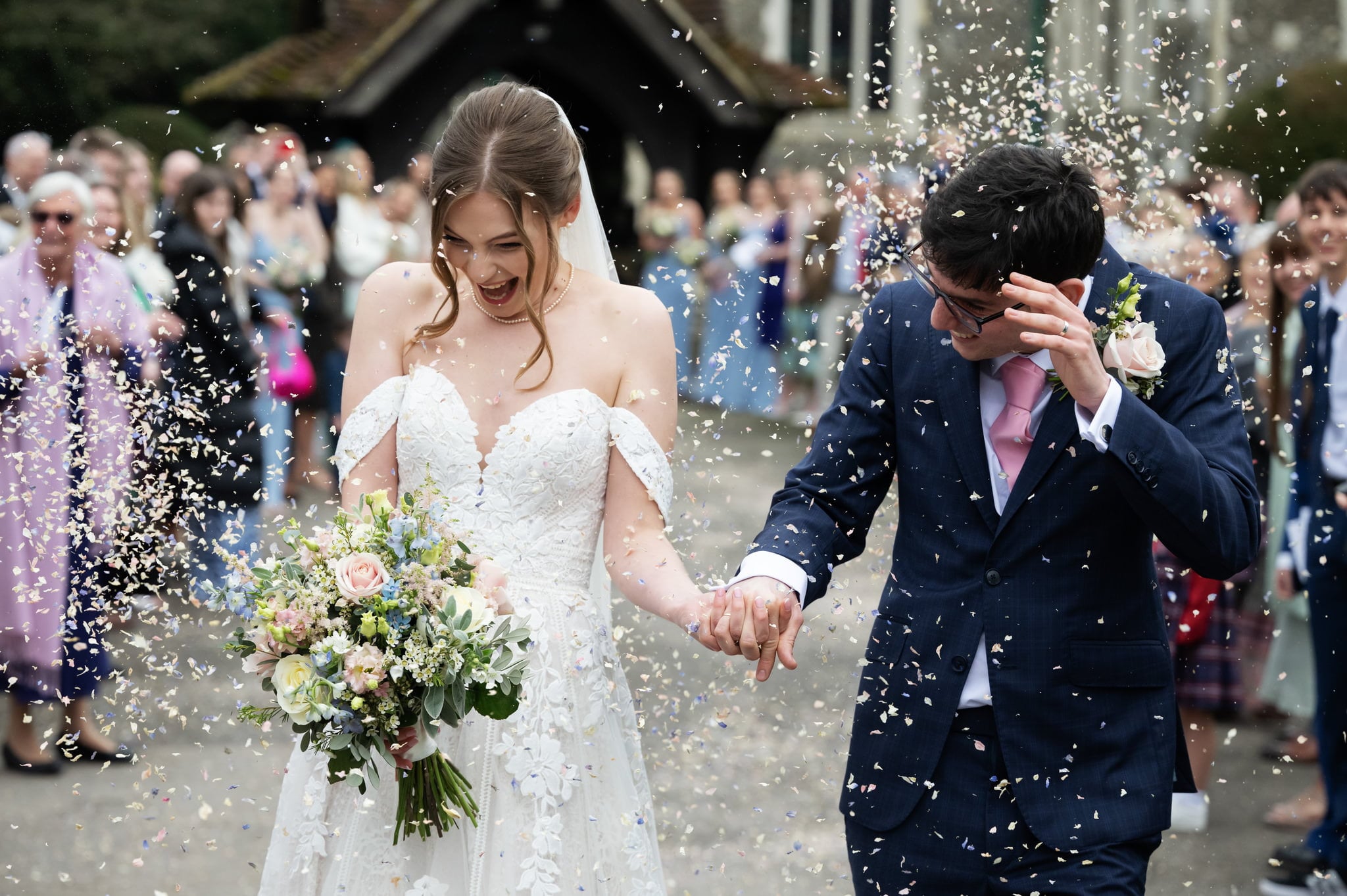 Bride and groom showered in confetti