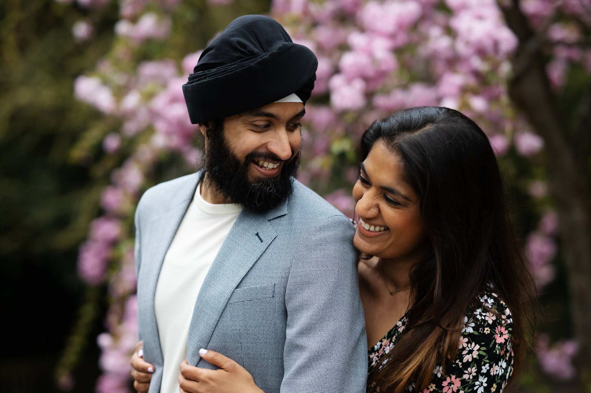 A couple in a turban smiles during a Holland Park photoshoot.