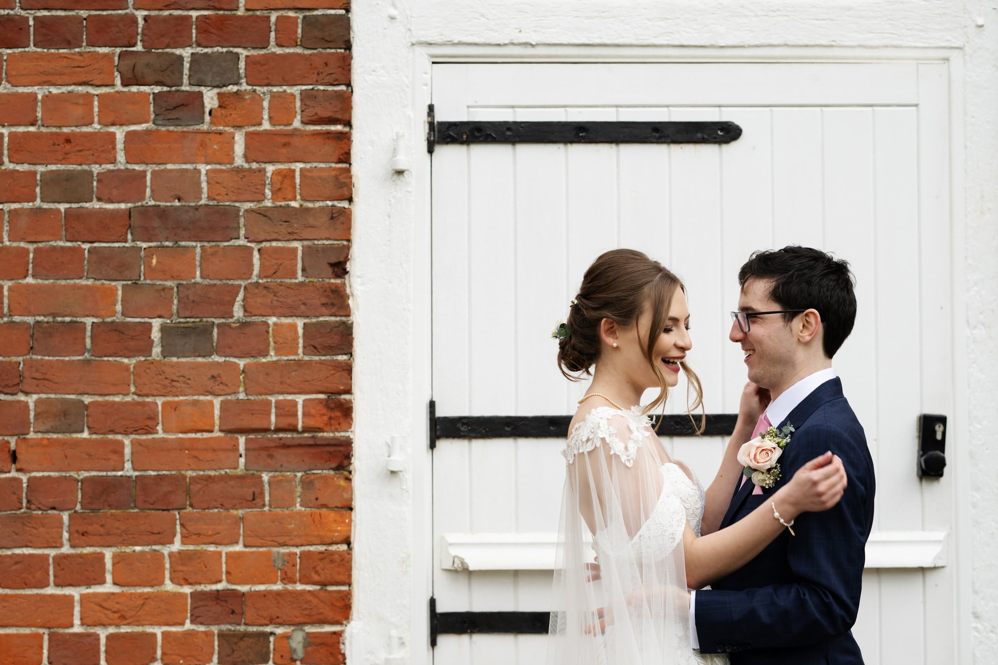 A bride and groom portrait at a barn door at Lillibrooke Manor wedding
