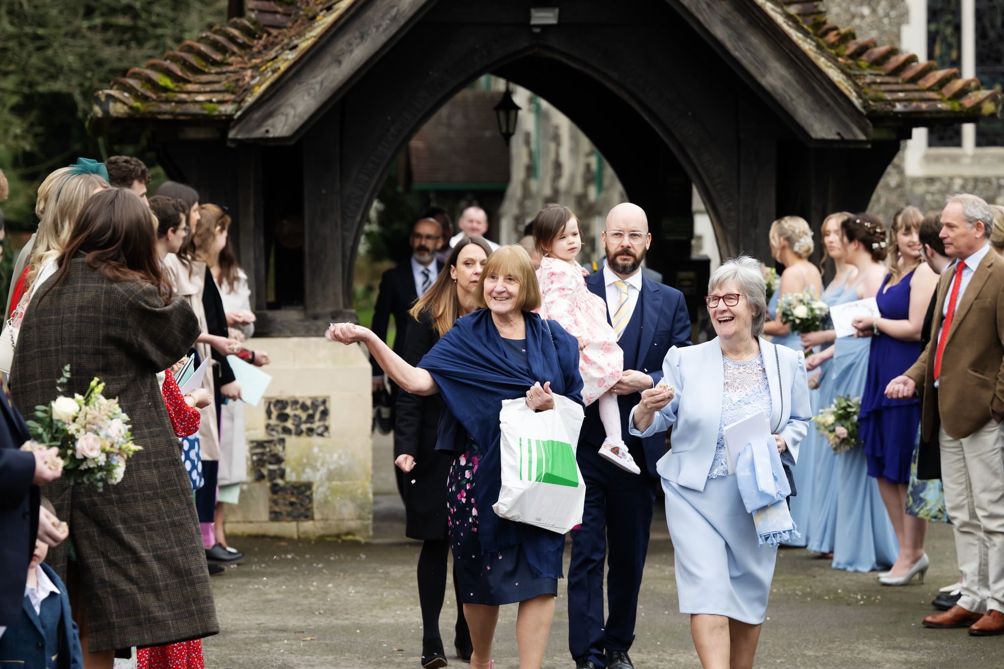 A couple walking down the aisle at Lillibrooke Manor for their wedding, photographed by a professional.