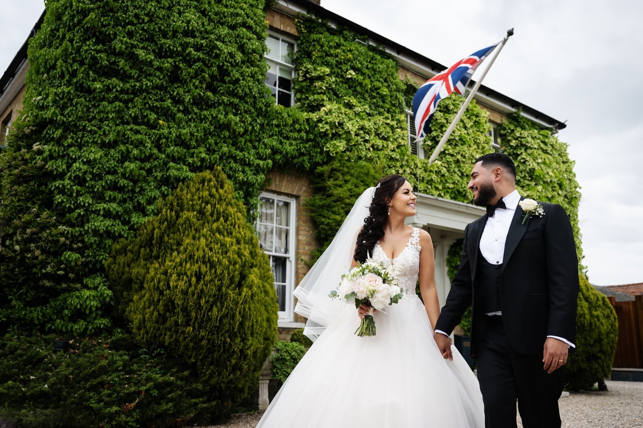 Bride and groom portrait in front of Friern Manor