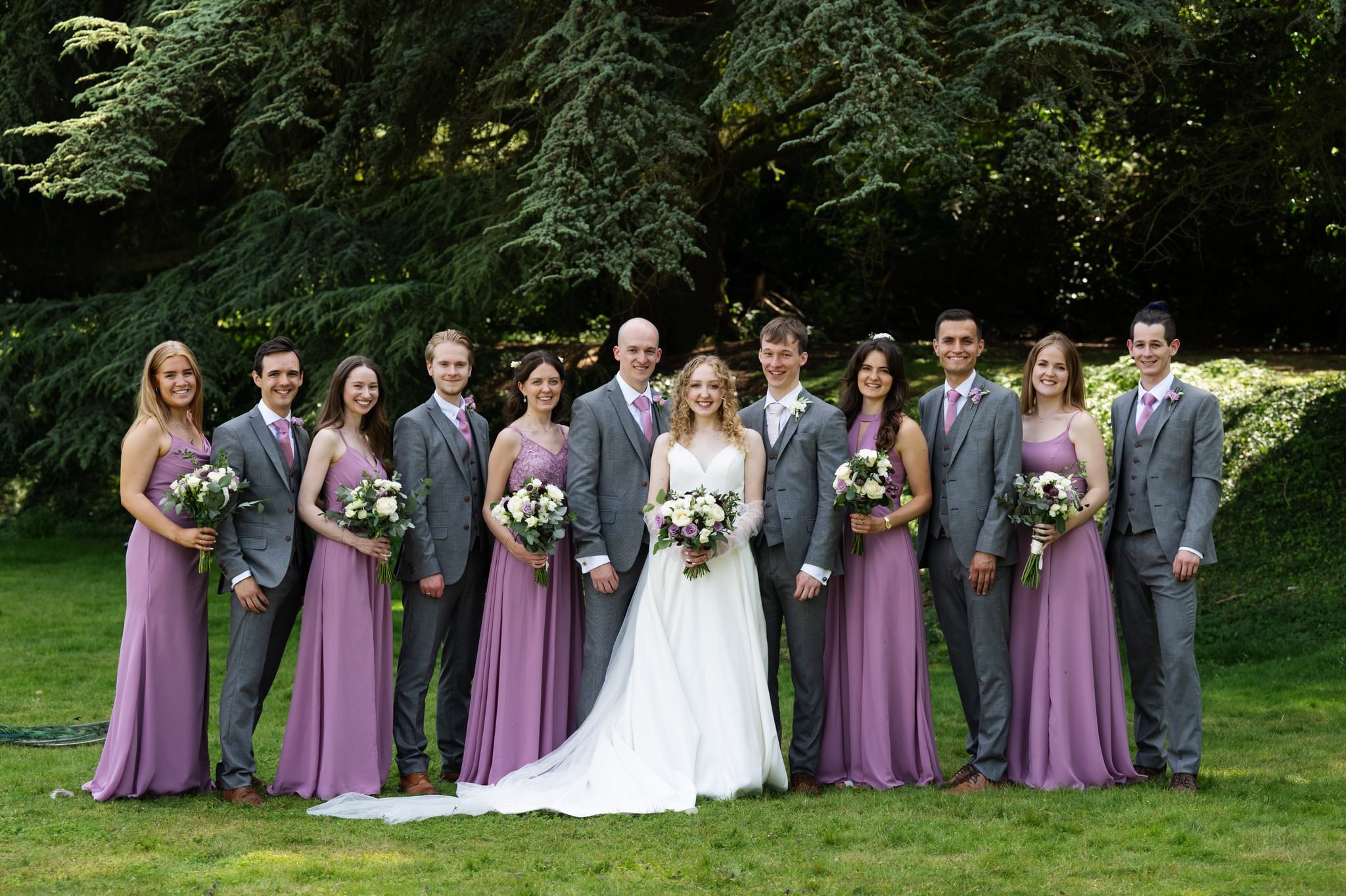 A group photo of the bride and groom with their bridal party