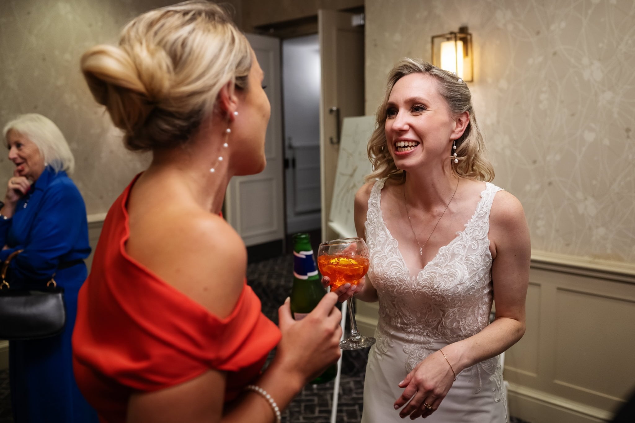 Two brides talking to each other at a wedding reception.