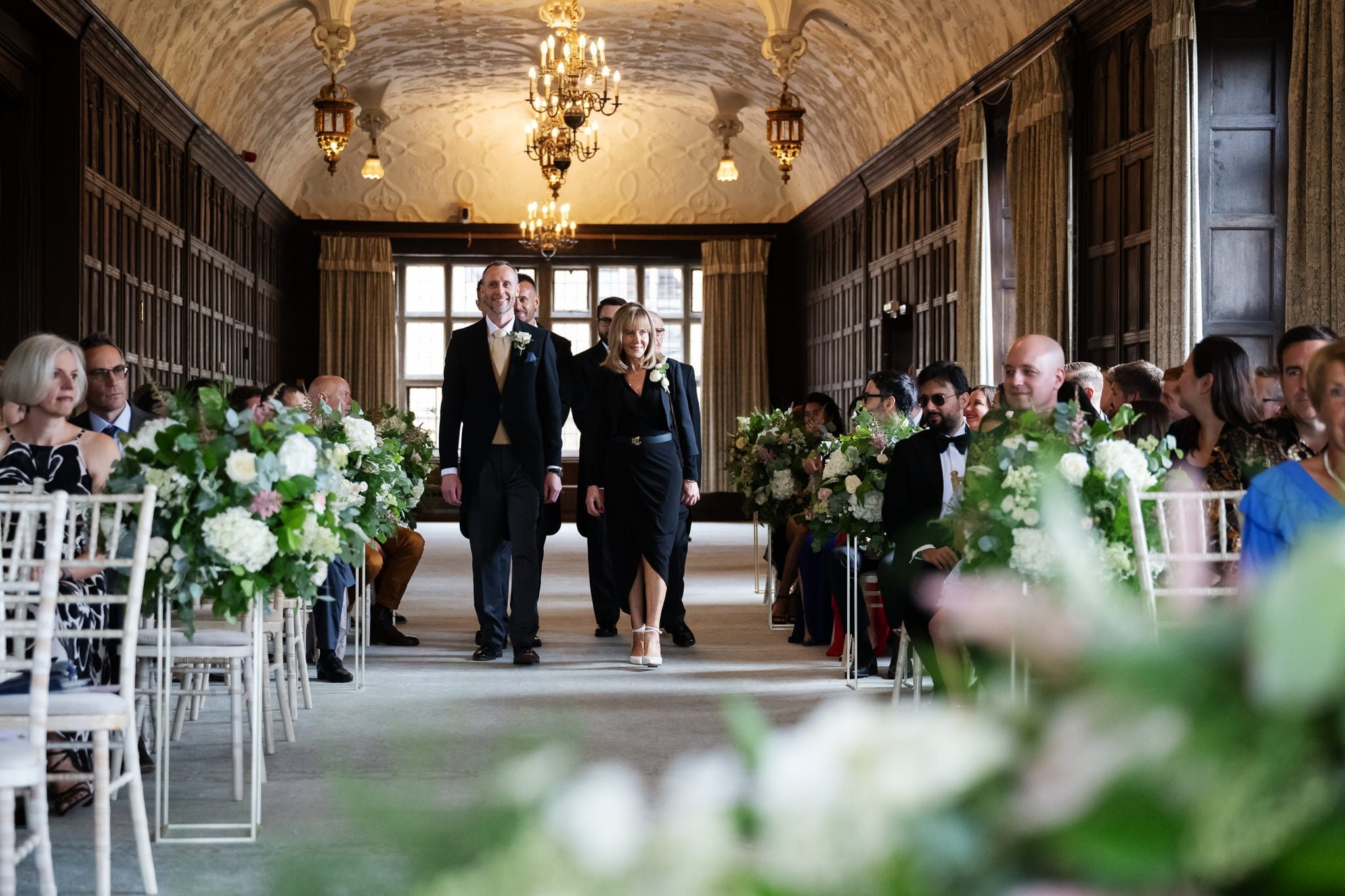 A bride and groom walking down the aisle at a wedding.