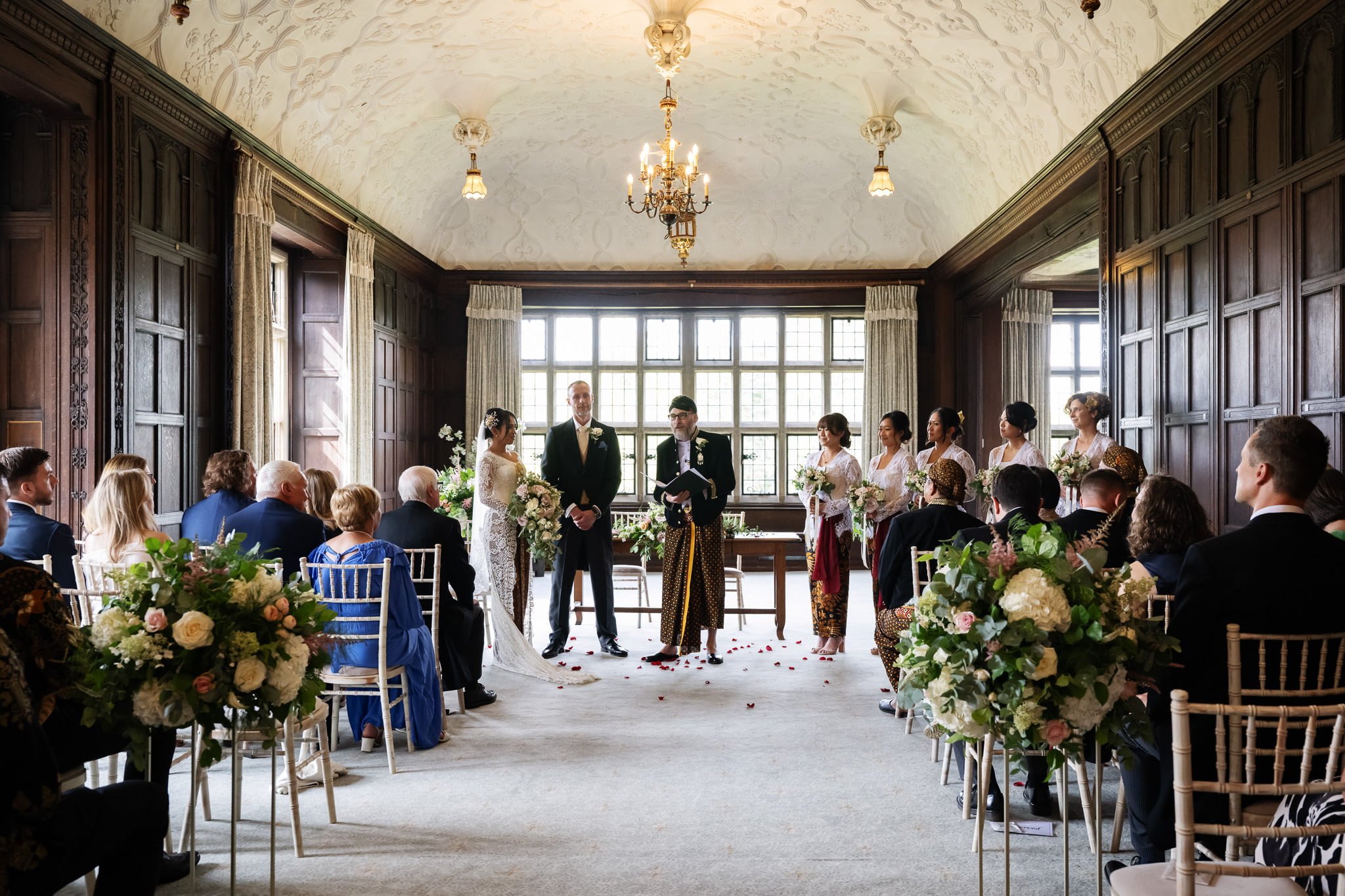 A wedding ceremony in an ornate room.
