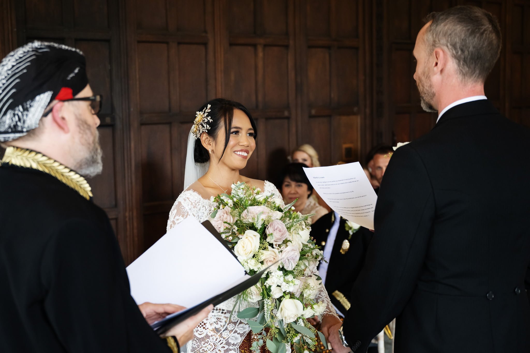 A bride and groom exchange vows at a wedding ceremony.