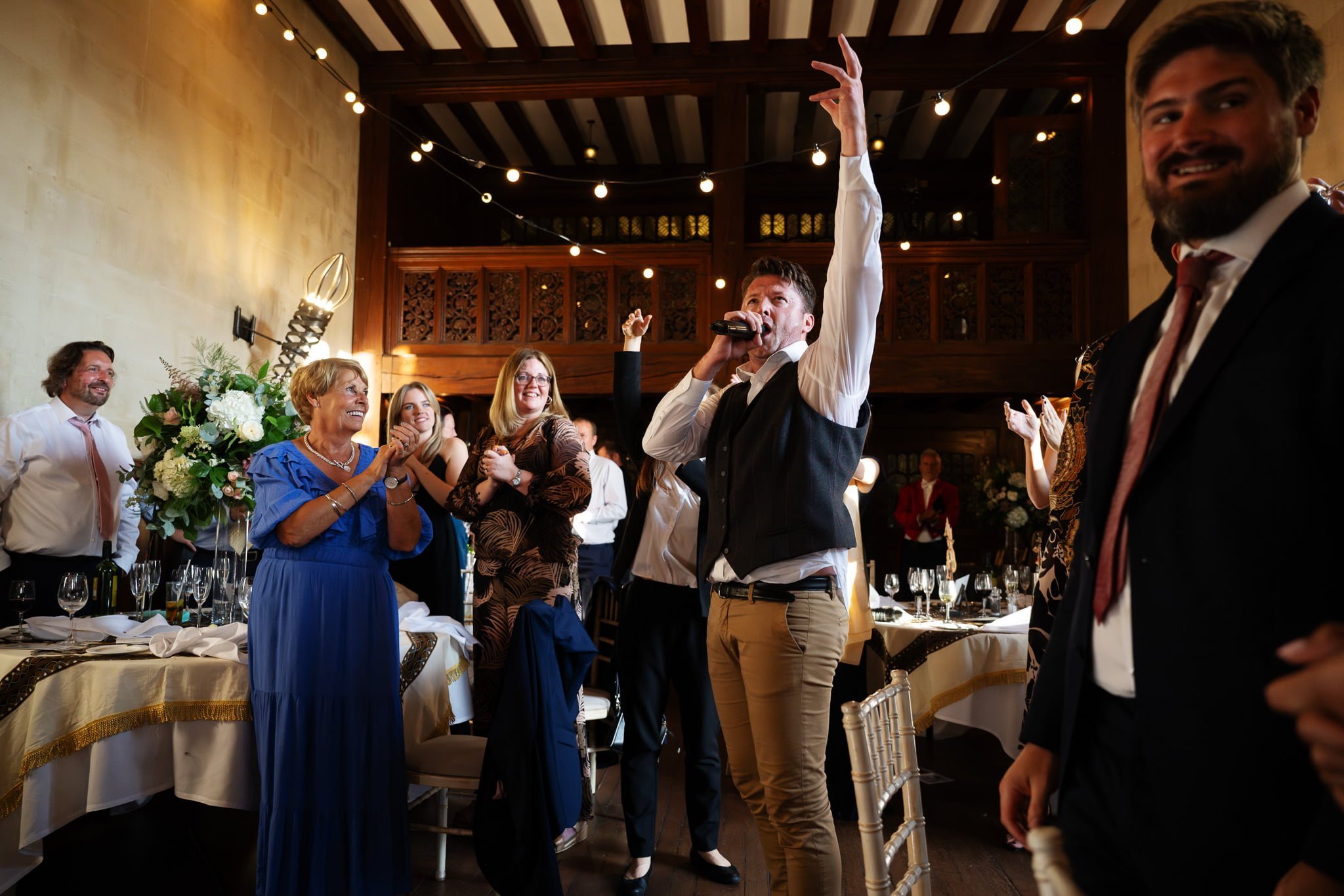 A man is waving his hands in the air.