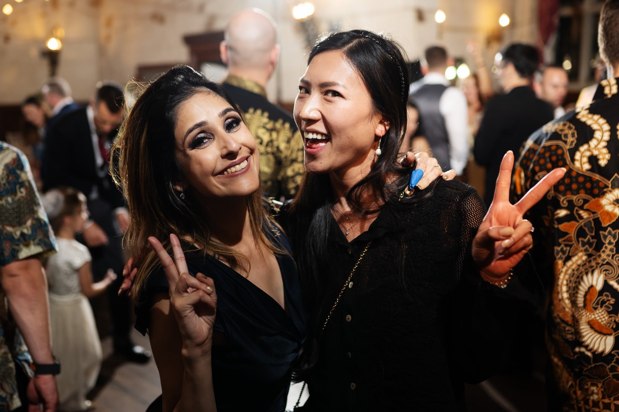 Two women posing for a photo at a party.