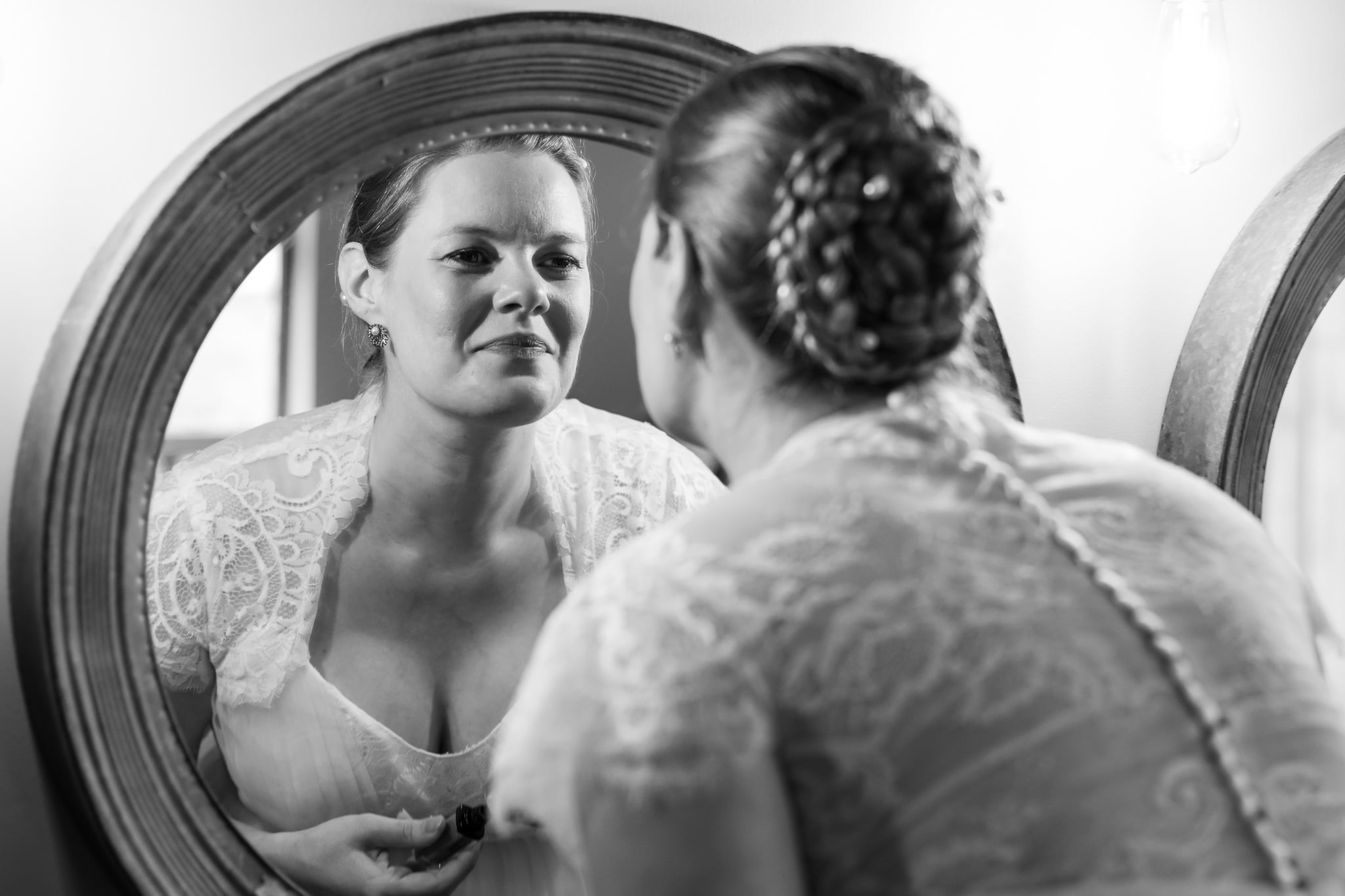 A bride looking at herself in a mirror.