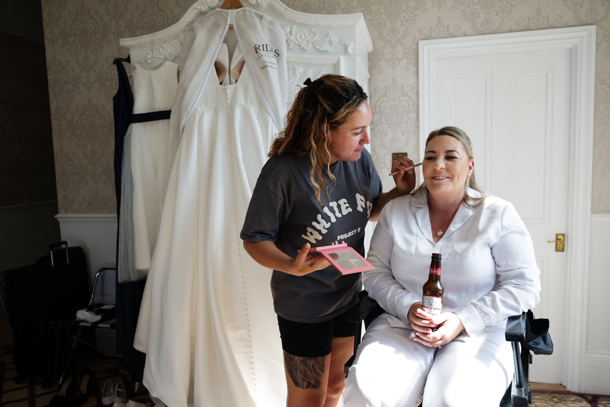 The bride has her makeup done on the morning of her wedding day.
