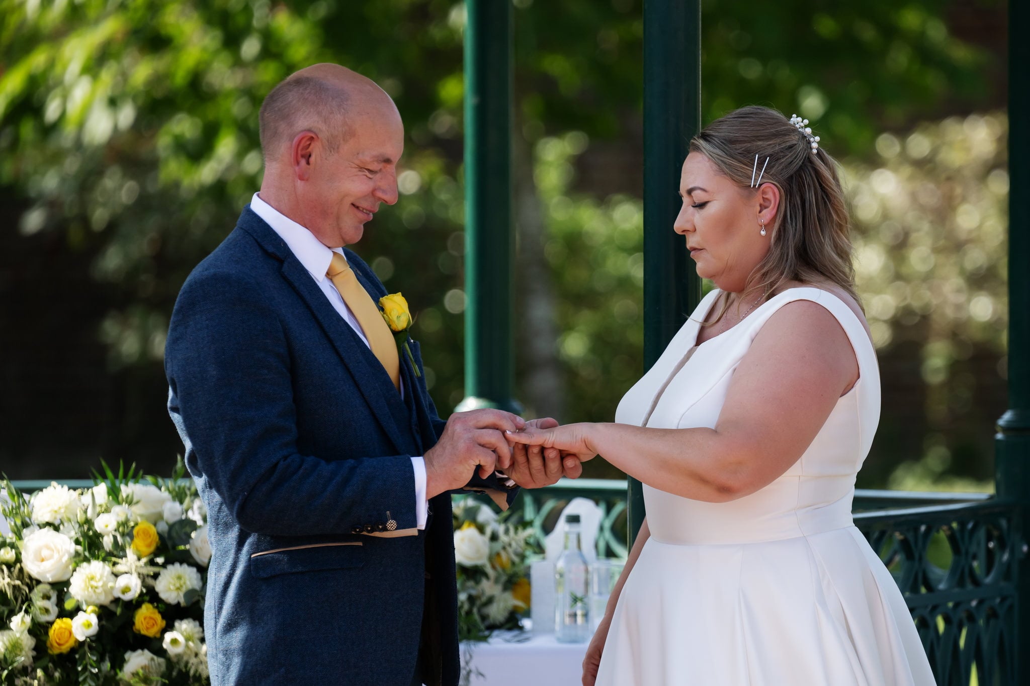 A bride and groom exchanging their wedding rings.