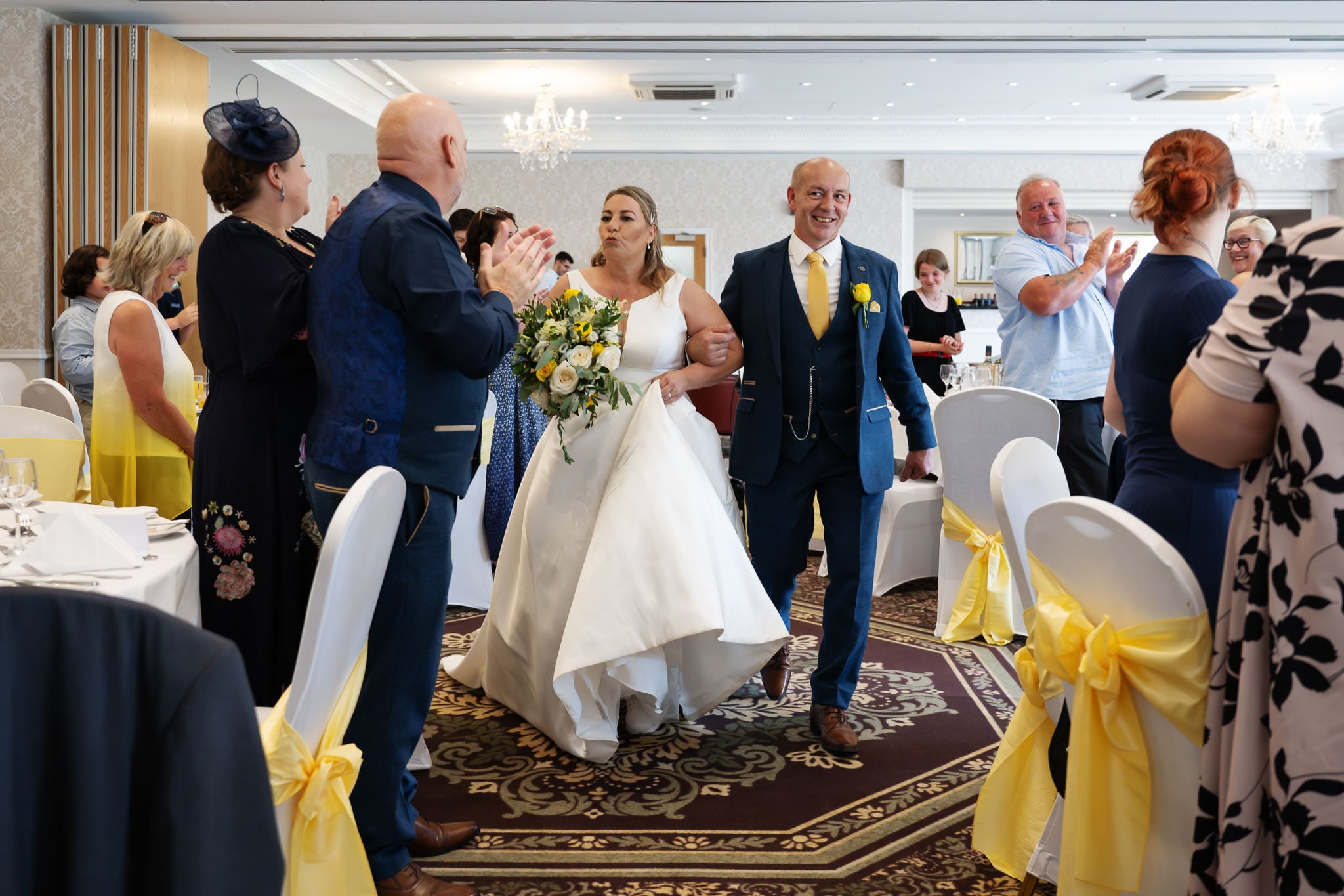 A bride and groom walking down the aisle.