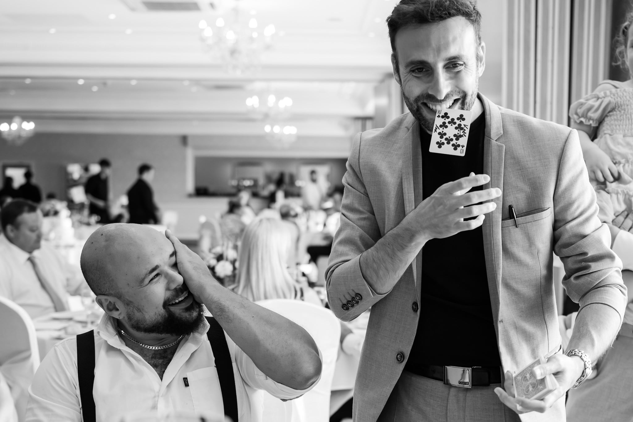 Black and white photo of two men at a wedding.