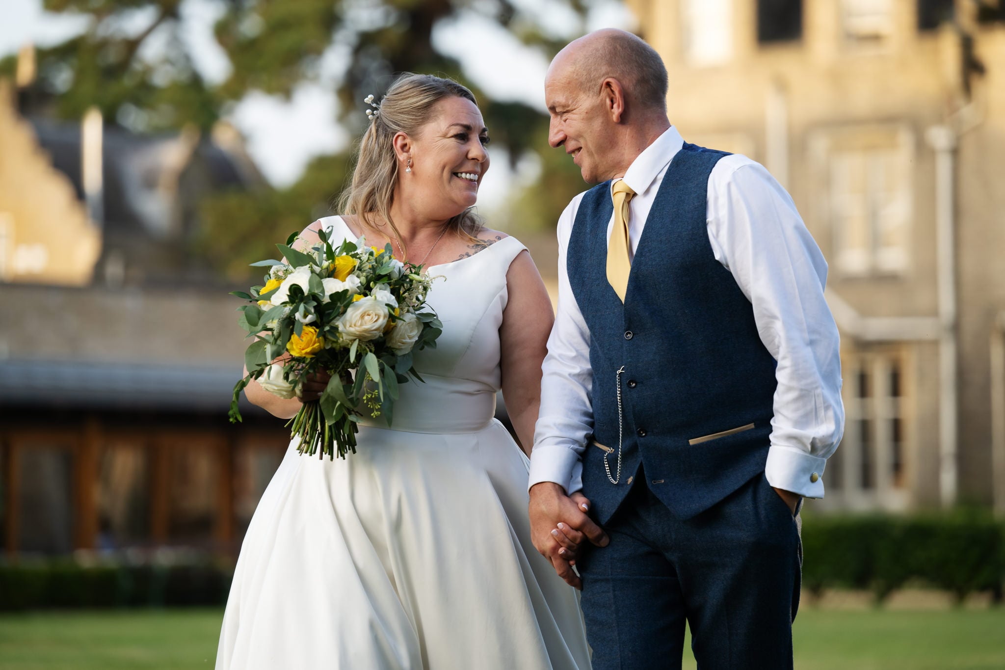 Bride and groom walking in the grounds of Shendish Manor
